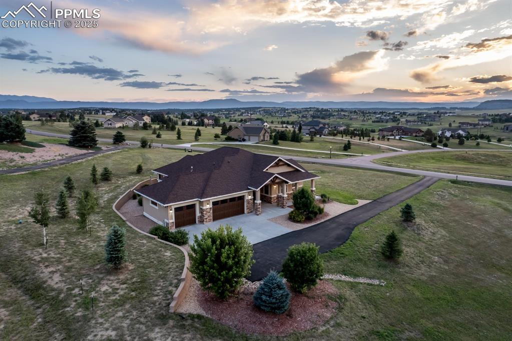Welcome home to this beautiful rancher on 2.5 acres in Monument’s desirable King’s Deer neighborhood. With incredible 360-degree mountain views, 10-foot ceilings throughout, and plenty of room to breathe, this home checks every box.

Inside, you’ll find a thoughtfully designed, zero-entry layout with 3 spacious bedrooms, 3 full baths, and a heated 3-car garage with fully insulated walls and ceiling. Solid oak floors run throughout the main living areas, adding warmth and character. The home is professionally cleaned twice a month and is incredibly well-maintained.

The great room features vaulted ceilings, large windows that capture the mountain views, and a cozy gas fireplace. The kitchen is ideal for anyone who enjoys cooking or entertaining, featuring granite counters, stainless steel appliances, a 5-burner gas cooktop, a spacious center island with seating, and a generous pantry.

The primary suite is a peaceful retreat with scenic views and a private bathroom that includes a zero-entry walk-in shower, double vanity, granite counters, and a spacious walk-in closet. In addition to the primary, there are two more bedrooms, two bathrooms, and a dedicated office, offering plenty of flexibility for guests, family, or working from home.

Step outside to a large patio that’s ideal for relaxing or hosting friends, with wide open views and a beautifully landscaped yard with native plants and lots of space to enjoy.

Located in the King’s Deer Golf Course community with trails, parks, and District 49 schools nearby, this home combines comfort, convenience, and Colorado living in one amazing package.