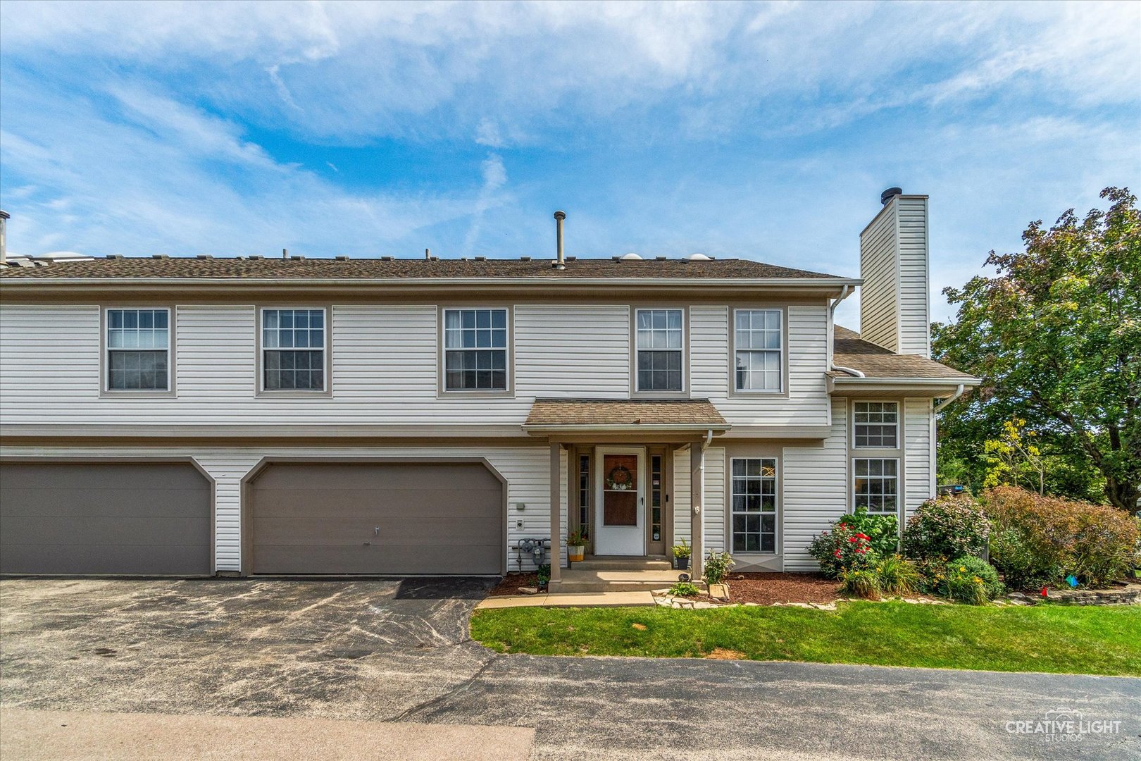 This spacious end unit is filled with natural light via the many windows and the skylights.  Two story home with private entrance the eat-in kitchen was updated in 2021 with new cabinets, quartz counters, glass tile back splash and the smart refrigerator, dish washer (2025). The large family room offers a vaulted ceiling and wood burning fireplace. The main floor also has the laundry room, power room and new luxury vinyl floors (2025). Upstairs you will find the generously sized primary bedroom with vaulted ceiling, ceiling fan with light, walk-in closet and access to the full bath with double sinks, jet tub and separate shower.  Plus a second bedroom and large loft.  Other great features are the 2 car attached garage, pull down stairs to additional storage in attic and a private patio. The air-conditioning and furnace were we replace in 2015.  Great location within district 200 schools and easy access to I88! Welcome home!