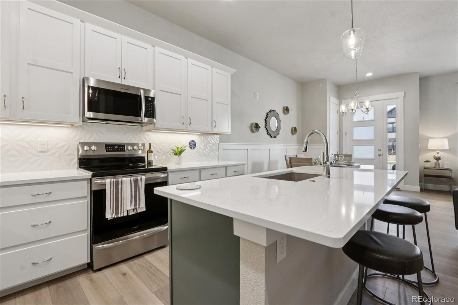 ***$5K CONCESSIONS*** Stunning model home in the highly sought-after Highlands at Fox Hill community! This beautifully upgraded townhome at 176 High Point Dr offers 2,028 sq ft of modern living with 3 bedrooms and 3.5 bathrooms. Designed with comfort and style in mind, the home features soaring 10' ceilings on the main level and 9' ceilings upstairs and basement, creating a bright and open atmosphere. The UPGRADED KITCHEN is a standout with quartz countertops, full tile backsplash, 42" upper cabinets with crown molding, stainless steel appliances and large island. The main living area is enhanced by laminate plank flooring and a cozy gas fireplace with tile surround-perfect for entertaining or relaxing evenings at home. Retreat to the spacious primary suite featuring dual sinks, quartz countertops, and beautifully tiled shower surrounds. Additional highlights include a full finished basement with bedroom, bathroom, and wet bar. Energy-efficient systems including a 92% high-efficiency furnace and tankless water heater, and an attached 2-car insulated garage with opener and keyless entry. Enjoy low-maintenance living in this golf course community with access to the Fox Hill Club and resident-only amenities, all conveniently located in Longmont with easy access to dining, shopping, and commuting routes.