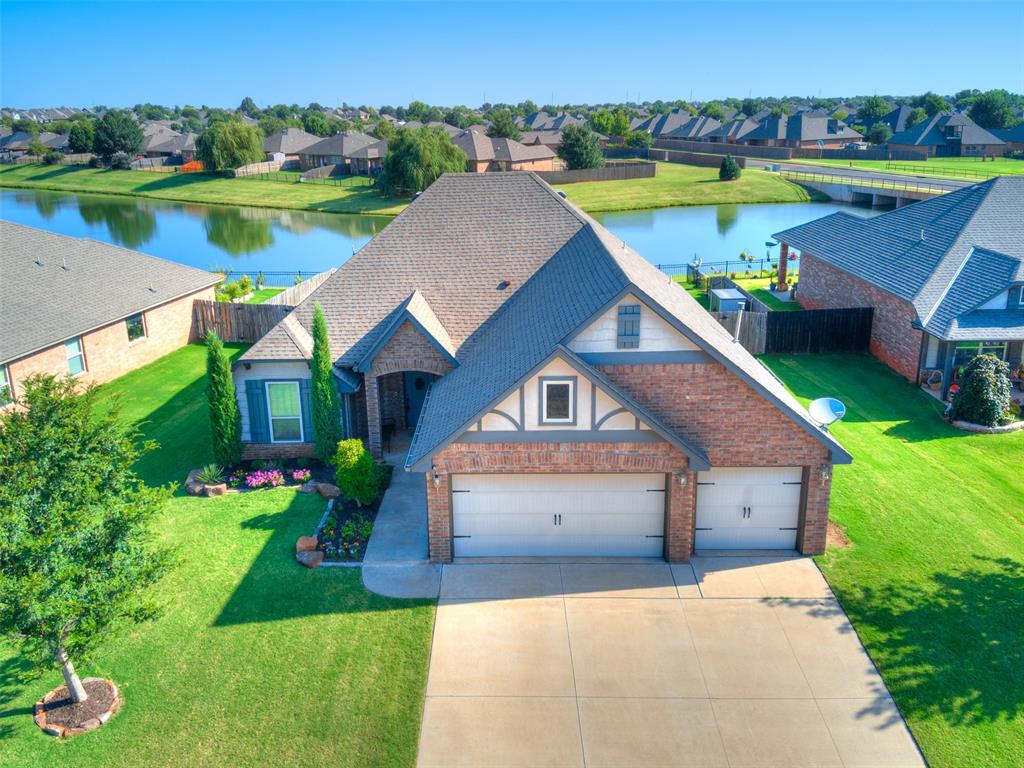 Located on a premier waterfront lot within the gated section of Lone Oak Lakes, this beautifully maintained home offers peaceful water views, a three-car garage, flexible bonus space, and recent improvements throughout, including a roof that is in process of being installed. The thoughtfully designed floor plan centers around an open-concept kitchen and living area, creating a seamless flow for everyday living and entertaining. The kitchen features granite countertops, a large island with bar seating, a walk-in pantry, and a gas cooktop, alongside a nearby dining area for meals and gatherings. The adjoining living room is anchored by a stylish fireplace and framed by serene water views. Refreshed paint and recently upgraded wood-look tile extend through the main living spaces, study, and primary suite. The spacious primary suite offers a private retreat complete with a large walk-in closet, dual vanities, a whirlpool tub, and a walk-in shower. Three additional bedrooms and a second full bathroom are conveniently located on the main level. Upstairs, an oversized bonus room with upgraded recessed lighting and its own full bathroom provides exceptional versatility as a game room, secondary office, guest suite, or additional living space. The backyard is a true standout, delivering an impressive outdoor living and entertaining area set against the water. An extended covered patio, equipped with speakers, a TV, string lights, and recently installed ceiling fan, creates the perfect backdrop to enjoy the views year-round. Additional highlights include a light-filled study, a spacious laundry room with built-in storage, a storm shelter, and an irrigation system. Combining privacy, scenic surroundings, generous layout options, and thoughtful updates, this waterfront home is an exceptional property.
