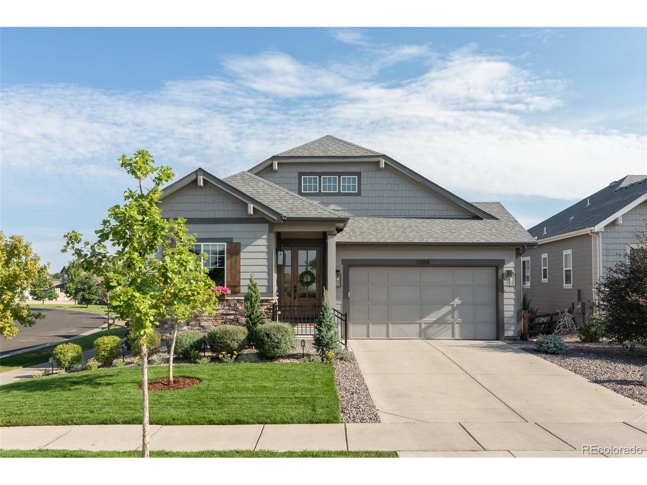 Nestled on a peaceful cul-de-sac in Overlook at Cherry Creek, this thoughtfully upgraded residence showcases refined interiors and an exceptional connection to open space. Recent improvements enhance the home, where an open-concept layout, beautiful hardwood floors and abundant natural light create a sophisticated yet inviting atmosphere. The expansive kitchen features sleek countertops, custom cabinetry, stainless steel appliances, a generous island and walk-in pantry, with a covered deck overlooking open space and the Cherry Creek Trail just beyond. The primary suite offers a tranquil five-piece bath and custom Alfa closet system, while a second main-level bedroom provides flexibility for guests or a home office. A garden-level basement adds two versatile bedrooms, a bath, spacious recreation area with a king sized Murphy bed, and a wet bar. A fenced backyard with a patio, attached two-car garage and direct trail access complete this exceptional offering near Parker's amenities, parks and E-470.