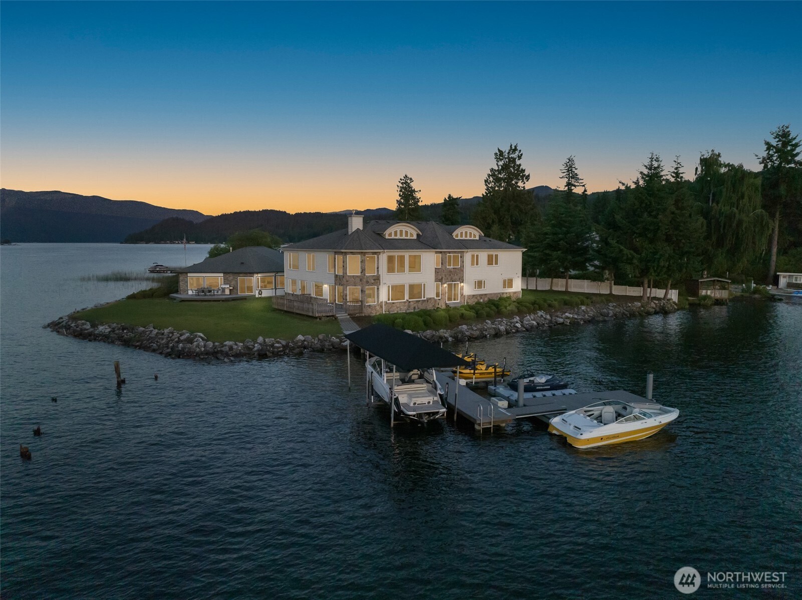 Own the POINT: A Stunning Estate, Discover the unparalleled beauty of this remarkable estate on Lake Whatcom, where luxury meets serenity. This magnificent multi-level home features 6 spacious bedrooms and 8 elegant bathrooms. As you step inside, you are greeted by exquisite solid cherry trim, doors, and cabinets that exude quality. The stunning Maple floors add warmth and character, while the custom kitchen, perfect for entertaining friends. The impressive two-story grand entry and living room create an inviting atmosphere, enhanced by the abundance of natural light pouring through oversized windows.This property originally envisioned as a turn-of-the-century hotel resort......experience lakeside living at its finest.
