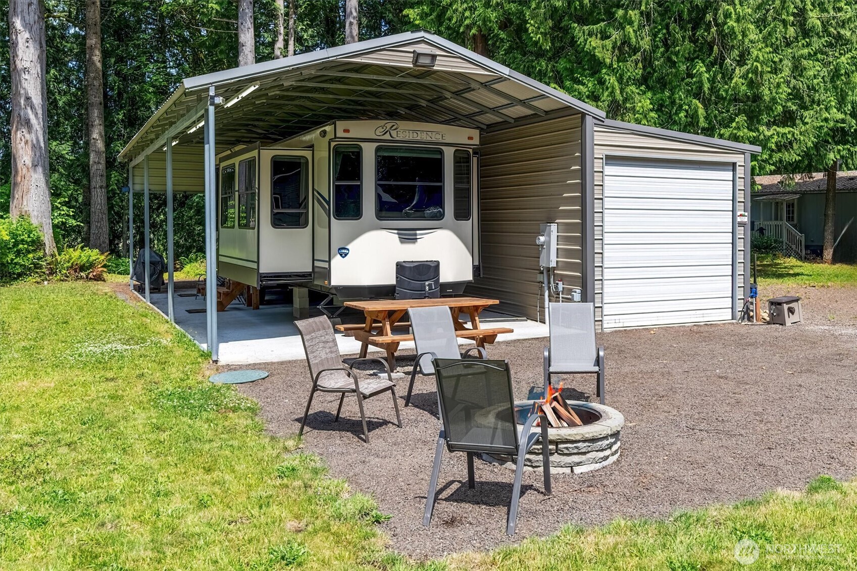 LAKE FRONT!! Wake up to a lake view 365 days with this flat buildable lot with loads of improvements! RV cover with slab, integrated electrical, sewer hook-up and water!  RV goes with the property, so you're ready to hit the water as soon as you close!  Attached extra large garage easily houses a pontoon boat AND extras! Hickory shed for added storage and approved fire pit. Located in Mayfield Kamper's Klub, this property offers extreme affordability with all the park extras, pickle ball court, walking trails, gated entry, playground and events, all for only $600/year, INCLUDING water and sewer! *sale is to become a shareholder in the club. Buyer must meet with club membership before closing.