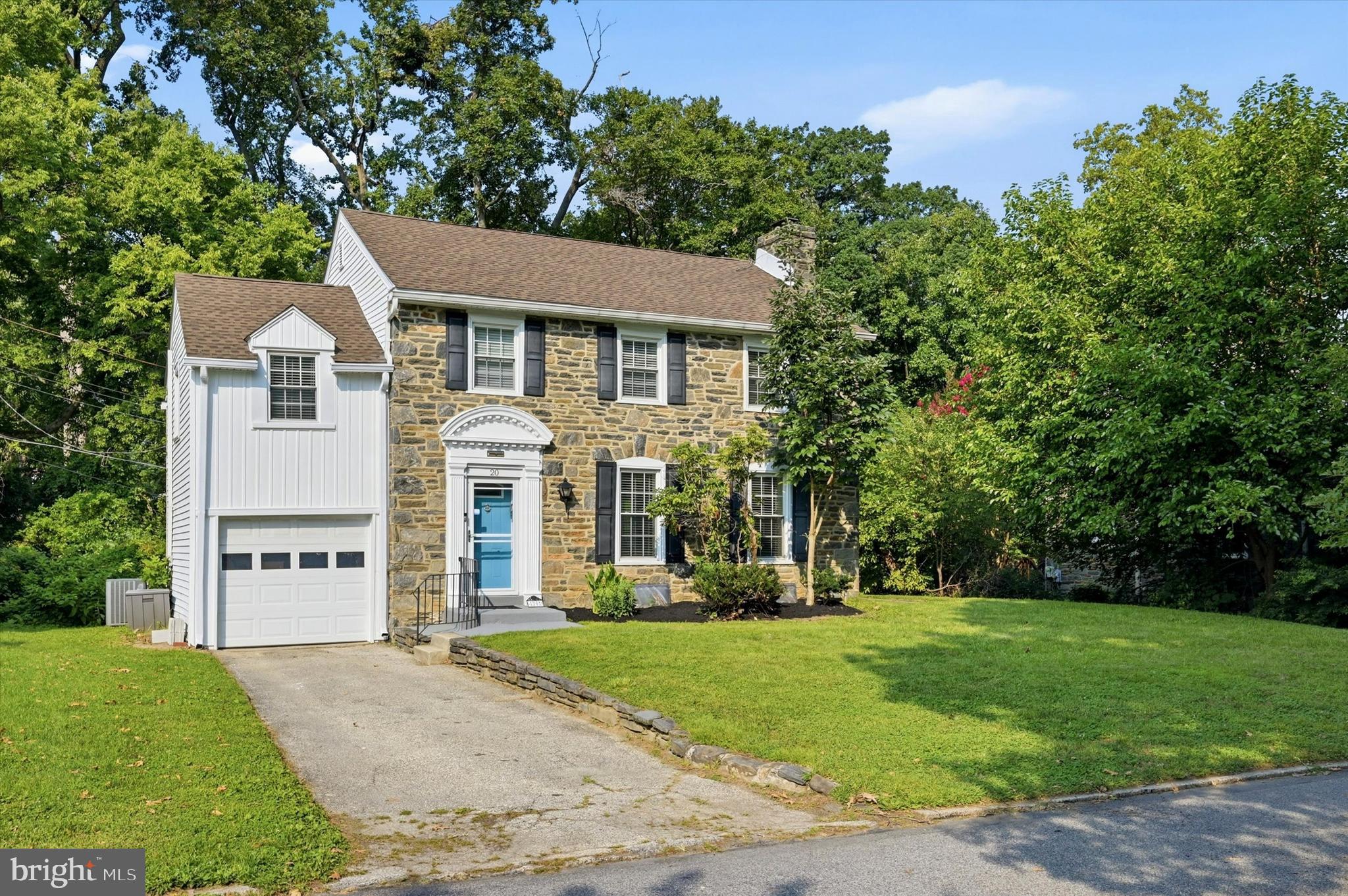 Welcome to this special gem in a great location and family-friendly neighborhood with excellent schools, plus close proximity to amenities and Center City! This enchanting 4 bedroom, 2 bathroom stone colonial sits on a generous lot with an attached one car garage, driveway and lush landscaping enhancing the curb appeal. This beauty with many upgrades is move-in ready and waiting for you. Interiors are inviting and elegant with hardwood floors throughout and comfortable spaces to relax and entertain, like the large living room with recessed lights, a cozy wood-burning fireplace opens to the gracious formal dining room. Connected for easy serving is the finely-appointed updated kitchen with sleek white cabinetry, granite countertops, backsplash, corner sink with gooseneck faucet, gas range and exhaust overhead hood and stainless steel appliances for the cook. Not to mention that the open formal dining room is perfect for gathering together for holiday dining or everyday meals while overlooking the private backyard.  Access to the rear private deck for summer barbecues, and enjoying a breath of fresh air. Serenity awaits on the upper level offering 4 hardwood bedrooms with 2 full bathrooms. The primary bedroom comes with its own nicely tiled en-suite bathroom featuring an updated vanity and a stall shower, the other 3 bedrooms share a tasteful full bathroom with a tub/shower. There is an unfinished basement with a walkout that could be turned into additional living space or a flex room.  Best of all is the prime address you have always dreamed of, steps from the Penn Wynne Park and easy to everything you need. What is not to love!