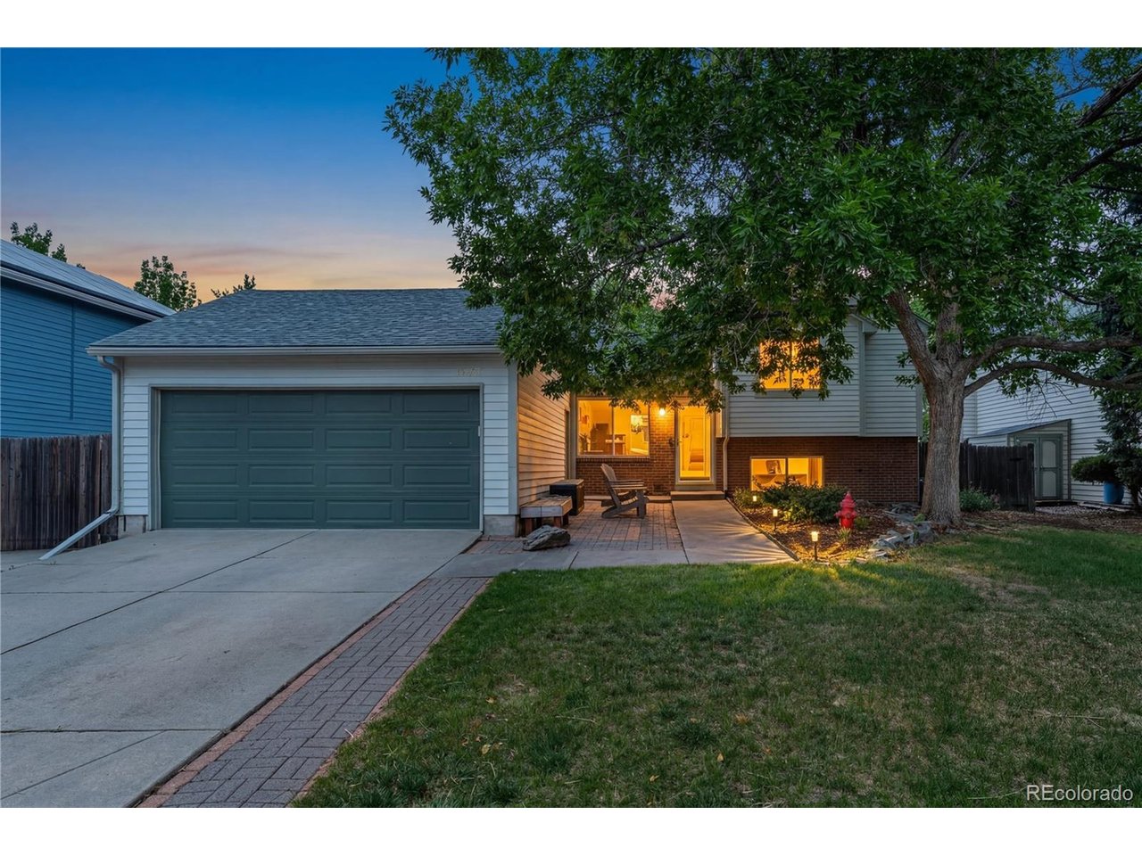 Beautiful tri-level home tucked on a quiet cul-de-sac just steps from Meadow Lake Park! Set on a mature tree-lined street in a welcoming neighborhood known for its great neighbors and unbeatable location, this home offers the perfect blend of comfort, space, and outdoor living. Enjoy easy access to the popular neighborhood park featuring a large lake, scenic walking trails, tennis courts, playgrounds, and expansive open space right outside your door. Pretty landscaping and a spacious front patio create a warm welcome. Inside, the open living and dining areas are filled with natural light and highlighted by vaulted ceilings, beautiful wood floors, and a timeless neutral color palette. Cozy up by the living room fireplace with charming red brick surround or step outside from the dining area onto the expansive deck, ideal for outdoor dining, entertaining, or relaxing evenings. The upper level offers two generous-sized bedrooms, while the lower level features an additional non-conforming bedroom, providing flexible space for guests, a home office, or hobbies. A beautifully updated bathroom completed in 2025 adds modern style and convenience. Energy-efficient solar panels help keep utility costs low. The attached two-car garage, oversized parking pad, and RV parking provide room for all your vehicles, toys, and outdoor gear. Walk to nearby shops, restaurants, King Soopers, and 24 Hour Fitness while enjoying the peaceful community feel and scenic lake setting that make this home truly special. Welcome home!