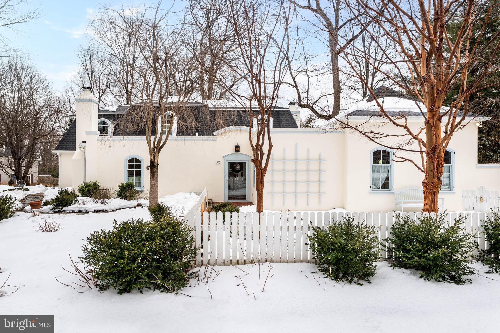 Graceful and quietly sophisticated, this French-inspired home embodies the best of Main Line living. Located in the desirable, well-established neighborhood of The Woods, its storybook curb appeal offers a warm and welcoming presence on the street. Mature gardens, picket fencing, arbors and pergolas frame professionally landscaped terraces with pea gravel and flagstone walkways throughout. A flagstone pathway leads to the home’s brick entrance. Inside, the large foyer feels gracious and inviting, conveying a sense of ease and understated elegance. Beautiful finishes, generous light and well-proportioned rooms create an interior that feels both comfortable and refined. Hardwood flooring runs throughout the home, setting a warm and cohesive tone from the entry. A powder room is conveniently tucked just off the foyer, along with a double coat closet. Gently curved doorways provide a subtle transition between rooms and reflect the home’s carefully considered design. To the left, French pocket doors open to the dining room, equally suited for intimate dinners and formal entertaining. Notable features include a striking fireplace, three sunlit windows, built-in display shelving and a door providing direct access to the kitchen. The living room evokes the feeling of a classic French home, centered around a finely detailed fireplace and framed by windows overlooking the backyard garden. Curved French double doors lead seamlessly to the gathering room with its floor to ceiling stone fireplace and wall of windows with views of the terrace, yard and whimsical playhouse. The room flows naturally into the spacious, eat-in kitchen with granite countertops and generous prep space. Glass doors open directly to the brick terrace creating an ideal setting for outdoor entertainment. A tiled- floor mudroom off the kitchen includes a coat closet, second powder room, laundry closet, rear entry from the driveway, and access to the two-car garage. One of the home’s most compelling features is the private, expansive first-floor primary suite with exceptional potential. The unfinished primary bath and walk-in closet present a rare opportunity for a new owner to create a custom retreat tailored to their own needs. Upstairs, to the right are two well-proportioned bedrooms which are connected by a renovated Jack-and-Jill bathroom with a tub. A third bedroom includes a renovated ensuite bath and adjoining sitting area or office, offering the flexibility to serve as a private guest suite or an additional primary bedroom. The partially finished basement includes utility space and storage. The property  features new Pella windows throughout, a four-zone HVAC system and newly installed shingle and flat roofs. Set in the award-winning Radnor School District and close to several prestigious private schools, this prime location offers the best of Main Line living. Minutes from the Paoli/Thorndale train stations, Wayne’s vibrant shops and dining, major commuting routes, medical facilities, universities and the King of Prussia Mall, this home is a true treasure. Private showings are available by appointment.
