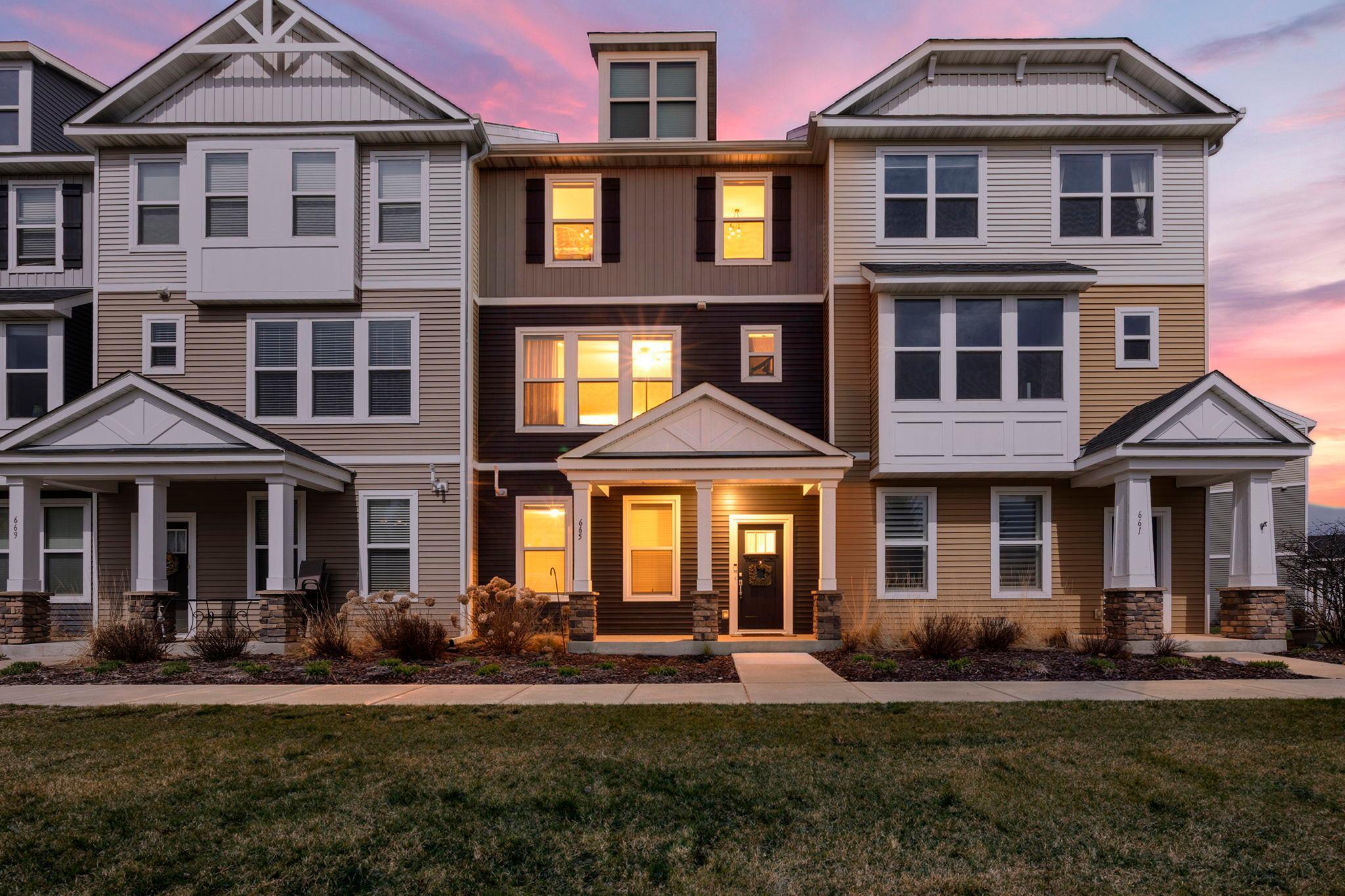 Stunning 3-bed, 3-bath townhome in desirable Chaska location with quick access to Highway 212, shopping, dining, and local amenities. Enjoy true maintenance-free living with HOA included snow removal, lawn care, and exterior maintenance. The entry level offers a welcoming foyer with LVP flooring, access to the attached two-car garage, and a spacious family room with abundant natural light. The main level features an open-concept design with LVP flooring throughout. The kitchen includes quartz countertops, center island with breakfast bar seating, stainless steel appliances, walk-in pantry, and a built-in desk nook. Step out to an 18x7 deck, perfect for relaxing or entertaining. The kitchen flows into a bright dining area and living room, plus a convenient main-level half bath. Upstairs includes three bedrooms, highlighted by a spacious primary suite with walk-in closet and private ¾ bath with dual vanities and walk-in shower stall. Two additional bedrooms share a full bath. A laundry closet with frontloading Whirlpool washer and dryer completes the upper level.