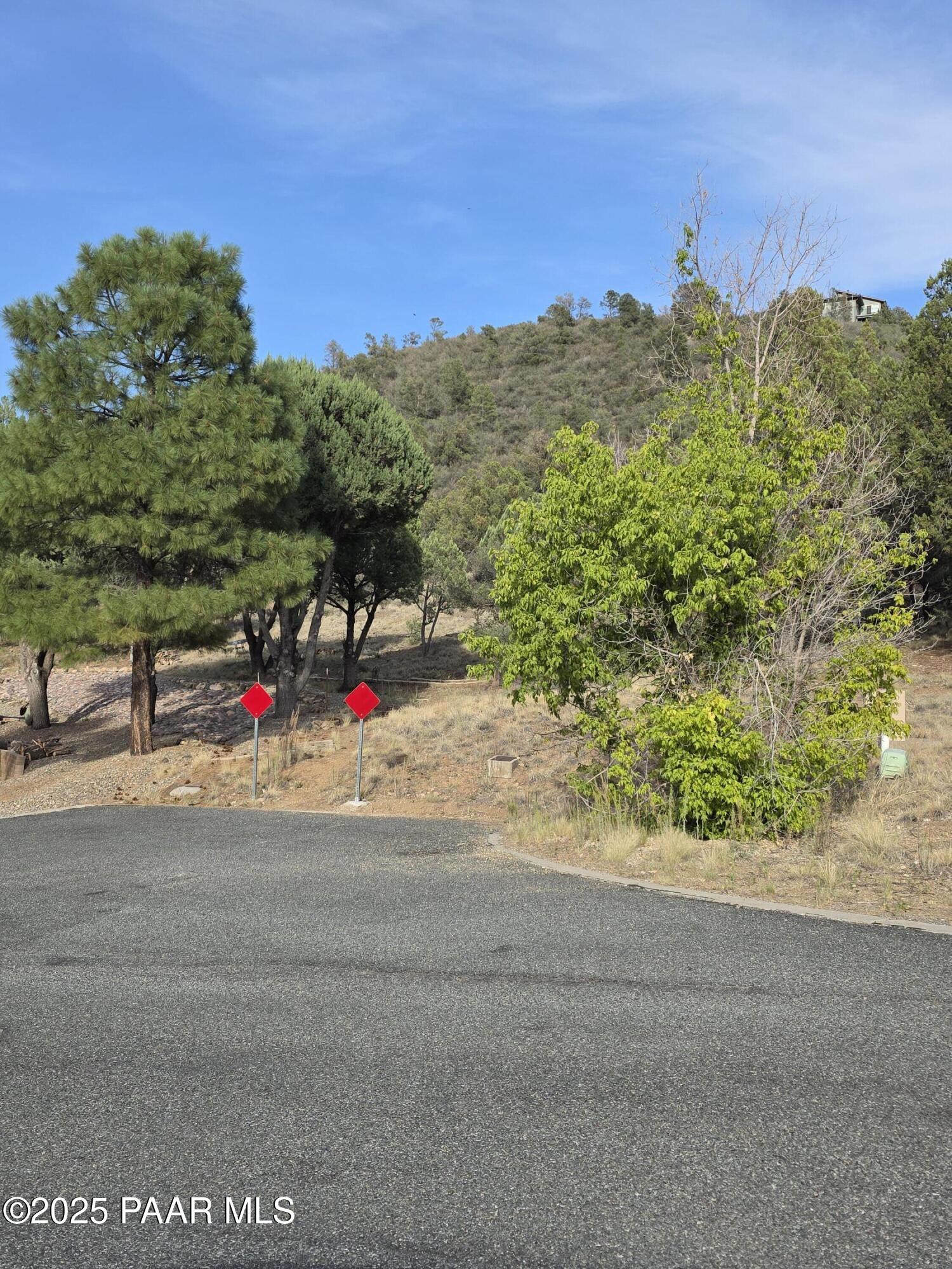 Developer special or room to roam on this conveniently located 5.21 acres. Approximately, 2 miles out Iron Sprins Rd, Well treed, paved access with views of Granite Mountain.  don't hesitate to call me for exact details and location.