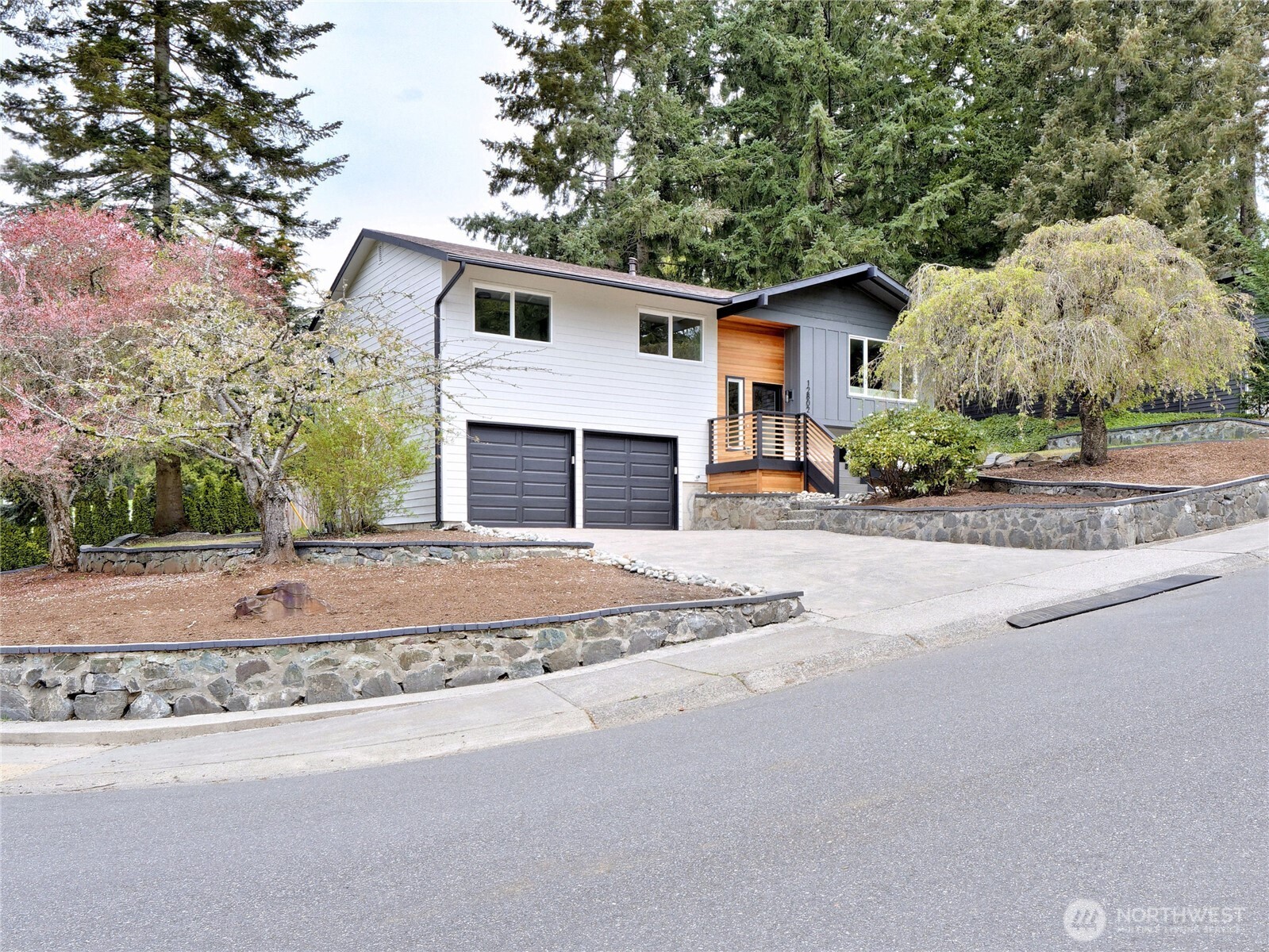 Sharply remodeled home in sought after Kingsgate 5 neighborhood. The main floor features an open living space with gas fireplace, dining room spacious new kitchen with quartz counters, stainless appliances, and a large center island. Easy access to the new deck and patio. This level also includes three bedrooms including the primary bedroom with tile shower. There is a second bathroom on this level to service guests and the other 2 bedrooms. Lower level has a family room with wood burning fireplace, a 4th bedroom/office and a 3rd bathroom. The home is equipped with gas hot water, a gas furnace and central A/C. The oversized 2 car garage has plenty of room for storage. This south facing 4 bedroom 3 bathroom home sits on a corner lot just 1 block from the community park, sports courts and swimming pool. Lake Washington Schools and Totem Lake shopping, restaurants and theatres are close by.