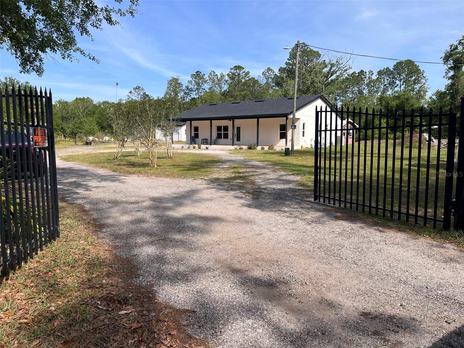 One or more photo(s) has been virtually staged. Welcome to your private oasis on a wooded 2.59-acre parcel, ideally located just minutes from Avalon Park, Waterford Lakes, UCF, and major roadways. This newly built 3-bedroom, 2-bath home features a detached 2-car garage and a 624 sq. ft. guest cabin—perfect for multigenerational living or rental income—offering a blend of peaceful country living and modern convenience.The open, light-filled floor plan showcases ceramic tile flooring, plantation shutters, and a split-bedroom layout for enhanced privacy. The spacious living area flows effortlessly into the dining space and kitchen, creating an inviting setting for everyday living and entertaining.A gated driveway and oversized parking area easily accommodate multiple vehicles, trailers, RVs, and boats. With A-2 zoning and no HOA, the property provides exceptional flexibility. Residents will also enjoy quick access to SR-408, SR-417, SR-528, Orlando International Airport, and Downtown Orlando. Schedule your private showing today. 24-hour notice required for all showings.