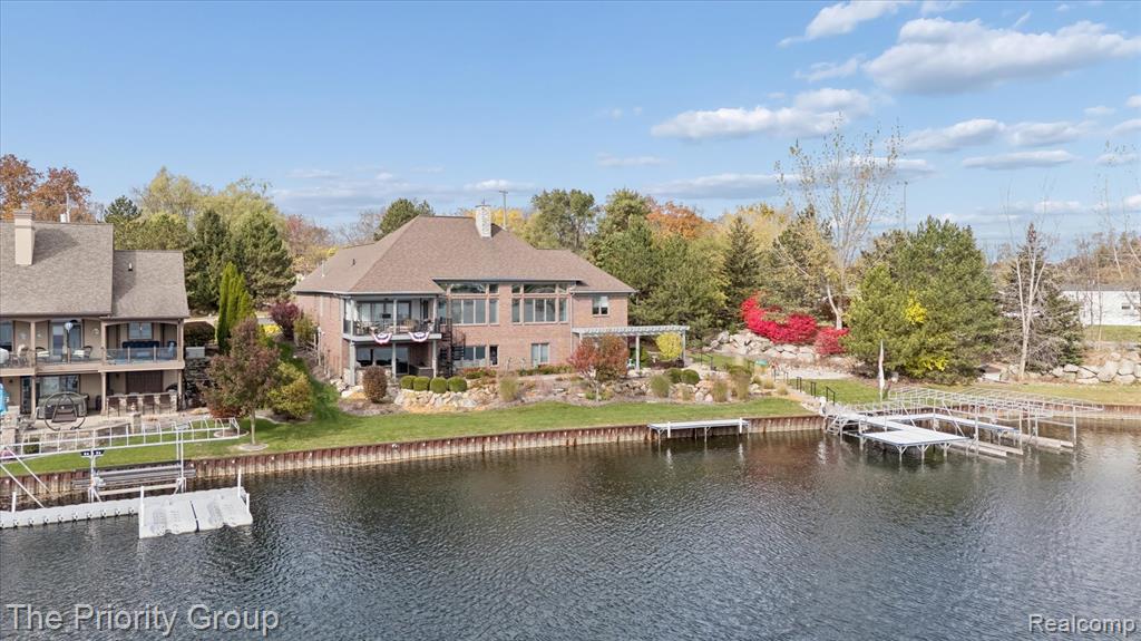 Exceptional Lakefront Living on the Coveted North Shore of Lake FentonExperience luxury, comfort, and true year-round lake living with this remarkable ranch on the highly sought-after North Bay Shore. Offering 150 feet of pristine frontage and 4,554 finished square feet, this 4-bedroom, 3.5-bath home captures breathtaking panoramic water views from nearly every room.From the moment you enter, soaring ceilings, abundant natural light, and stunning sunrise views set the tone. The open-concept main level is designed for both everyday living and entertaining. The lakeside kitchen features quartz countertops, stainless steel appliances, and a large island, all with uninterrupted water views. The great room showcases dramatic floor-to-ceiling windows overlooking the lake. Step outside to the covered balcony with ceiling fan and power screens for effortless indoor-outdoor living.The primary suite offers balcony access, wide-plank hardwood floors, and a spa-like atmosphere. A second main-floor bedroom with a walk-in closet and private bath is ideal for guests.The finished walk-out lower level expands your living space with a custom bar (microwave, dishwasher, beverage refrigerator), spacious recreation and family rooms, two additional bedrooms, a full bath with walk-in shower, & direct access to the patio and shoreline.Additional highlights include newly refinished Brazilian cherry hardwood floors, luxury vinyl plank flooring in the lower level, main-floor laundry, ample storage, & a heated two-car garage. Outdoors, enjoy beautifully landscaped grounds and expansive shoreline—perfect for boating, fishing, paddle-boarding, or lakeside gatherings.A rare opportunity to own a premier Lake Fenton property offering lifestyle, luxury, and location.Dock not included; available for purchase separately. Hoist Not Included & not available for sale.Listing Agent Related to the Seller.