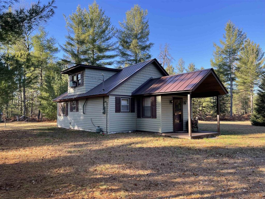 This "one of a kind" hunt camp is waiting for you to take that "Buck" and make memories!!! 20 acres m/l fronting M-33. The well maintained cabin is all set for large gatherings! Covered composite deck leads into a foyer entrance. First thing you will notice is the birch bead board and planking covering the vaulted ceiling and most of the walls. Open living area with spacious kitchen. Living room has a free standing wood stove. Two bedrooms and a 3/4 bath make up the remaining main level. Staircase leads to the loft area with dormer ~extra sleeping space and two spacious bedrooms. Exterior has newer vinyl siding and steel roofing. Enjoy cooking outdoors over the fire pit. Close to the cabin is a garden shed for storage and a small pavilion plus circle drive. Borders 1,000 acres of state land on the north property line. Great location not far from I-75 and approximately 7 miles to West Branch.