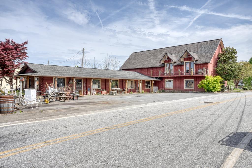 Prime commercial opportunity in the heart of Hiawassee! This large building offers excellent functionality with multiple showrooms, a kitchenette, two half baths, gas log fireplace and dedicated storage space. Situated on approximately 0.22 acres, the property includes both the building and land, providing outstanding flexibility for a variety of business uses. Located on Main Street, this high-visibility location benefits from steady traffic flow and is within walking distance to local shops. Ample on-site parking enhances accessibility for customers and staff alike. Connected to city water and sewer. Endless potential in a highly desirable location! Call me today!
