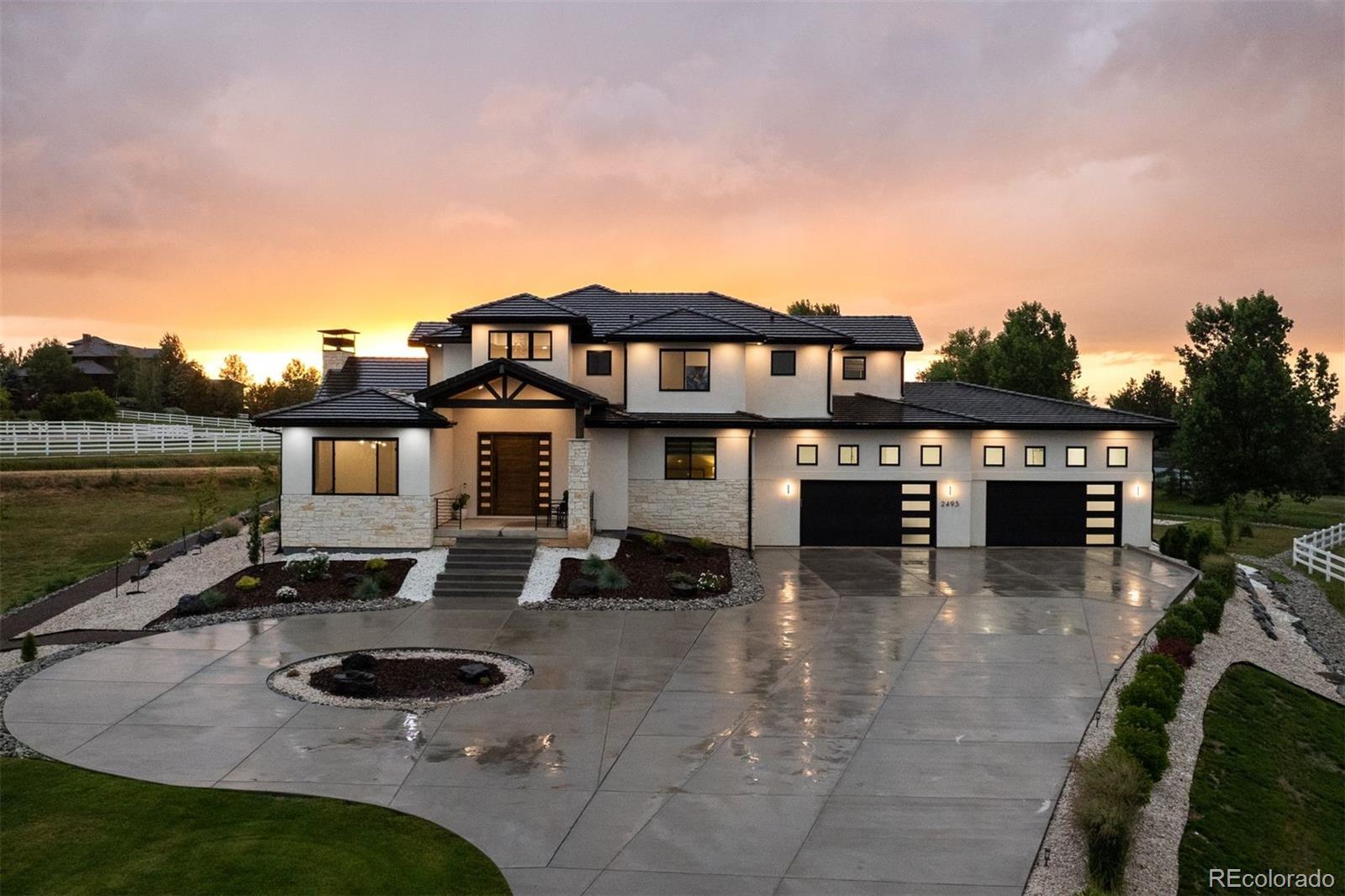 Custom Modern Indulgence Meets Colorado Grandeur-Remarkable quality, sleek sophistication, and breathtaking views converge in this extraordinary custom estate. Perfectly positioned on a premier cul-de-sac in Broomfield’s most distinguished enclave, 2495 Red Hawk Place is a rare architectural triumph—bold in design, rich in detail, and indulgent in lifestyle. Framed by sweeping views of Longs Peak and set on a meticulously landscaped lot, this 8,400-square-foot masterpiece unfolds with intent—each space crafted for elevated living and effortless entertaining. A dramatic floating staircase with 8-inch solid Hickory treads and custom wrought iron railing sets a tone of artisanal excellence. Cathedral-style ceilings with hand-hewn beams, hand-troweled wall textures, and wide-plank solid wood flooring infuse the home with warmth and quiet opulence. The sunroom, with its marble flooring and gallery-lit feature wall, offers a tranquil space for art or reflection. At the center, the chef’s kitchen blends high function with bold custom design:lighted stacked cabinetry, a tuxedo quartz waterfall island, dual dishwashers, and a full suite of Thermador appliances—including a 6-burner range with griddle and commercial-grade refrigerator—create a culinary experience of the highest caliber. A massive walk-in pantry provides both scale and elegance. All five bedrooms are private en-suites, including a stunning primary retreat with balcony, spa-like bath, soaking tub, rain shower, marble floors, and bespoke lighting. The expansive lower level continues the indulgence with a full wet bar, home theater, fitness room, guest suite, and access to an outdoor basketball court, perfect for recreation under the Colorado sky. Additional features include two full laundry areas, an outdoor kitchen, heated patios, a pet wash station, and a 6-car heated garage. Seamlessly blending timeless luxury with modern comfort, this home is a masterclass in custom design—iconic, tailored, and unforgettable.