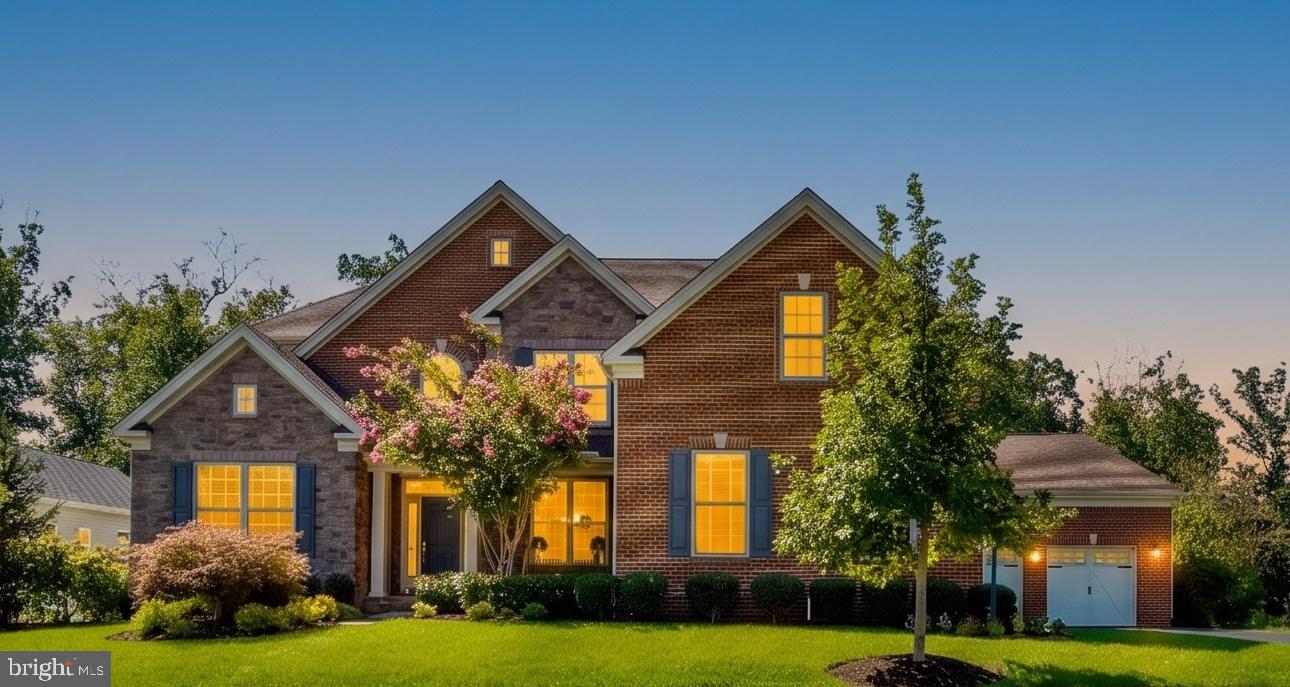 A rare combination of refined design, exceptional space, and wooded privacy, this distinguished Toll Brothers residence offers approximately 5,940 square feet of beautifully finished living space on a 0.33-acre lot. A stately brick-and-stone façade, manicured landscaping, and an extraordinary five-car garage create an impressive first impression.Inside, a light-filled open floor plan is elevated by hardwood floors, extensive millwork, elegant wainscoting, crown molding, and a graceful staircase with wrought-iron balusters. Generously proportioned formal living and dining rooms provide an inviting setting for entertaining, while the expansive family room offers a relaxed gathering space centered around a handsome stone fireplace.The beautifully appointed kitchen is the heart of the home, featuring crisp white cabinetry, a large center island, stainless-steel appliances, a professional-style gas range, and abundant workspace. Dramatic arched windows frame tranquil woodland views and fill the kitchen with natural light. The adjoining breakfast area and family room create an effortless flow for both everyday living and large-scale entertaining.Upstairs, the spacious primary suite is a private retreat with a tray ceiling, sitting area, and a luxurious renovated bath featuring dual vanities, a soaking tub, an oversized frameless glass shower, and designer tile. A small room off of the primary bedroom is perfect for a private sitting area, meditation room or another office. Four additional bedrooms and well-appointed baths offer exceptional comfort and flexibility for family, guests, or home-office needs.The expansive finished lower level adds an impressive dimension to the home, with abundant space for recreation, media, fitness, play, and entertaining. Outdoors, the level backyard with large play set backs to mature woods, providing a peaceful natural backdrop and a wonderful sense of privacy.With five bedrooms, four-and-a-half baths, nearly 6,000 finished square feet, and garage parking for five vehicles, this exceptional home delivers the craftsmanship, scale, and versatility for which Toll Brothers is renowned.