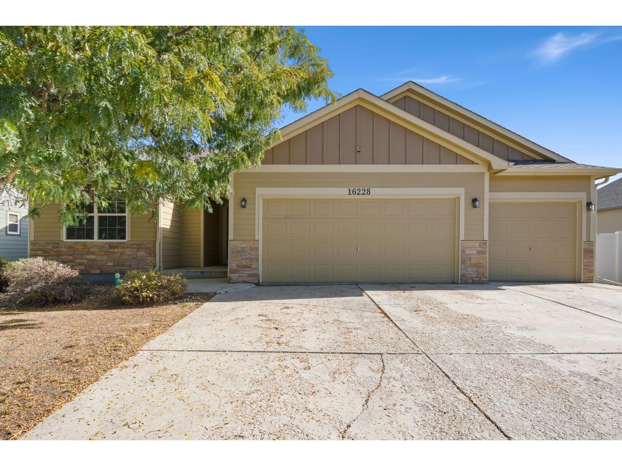 Set along a tree-lined street in an established neighborhood, this ranch-style home offers a bright interior and generous living spaces. The large living room features a vaulted ceiling and abundant natural light, while the kitchen offers ample cabinetry, counter space, and breakfast bar seating. An adjoining dining area with a bay window overlooks the backyard and provides access to a large back deck, extending the living space outdoors for dining and entertaining.The main level includes three bedrooms, two full bathrooms, and laundry. Set apart from the secondary bedrooms, the large primary suite includes a walk-in closet and private five-piece bath with dual vanities, a soaking tub, and a separate shower. The unfinished daylight basement offers nearly 1,400 square feet for future expansion, with windows that bring natural light into the lower level and ample space for storage. Outside, the fenced backyard offers room for gardening or future landscaping, and the attached three-car garage provides additional parking and storage. The home's location provides convenient access to downtown Mead and nearby schools.