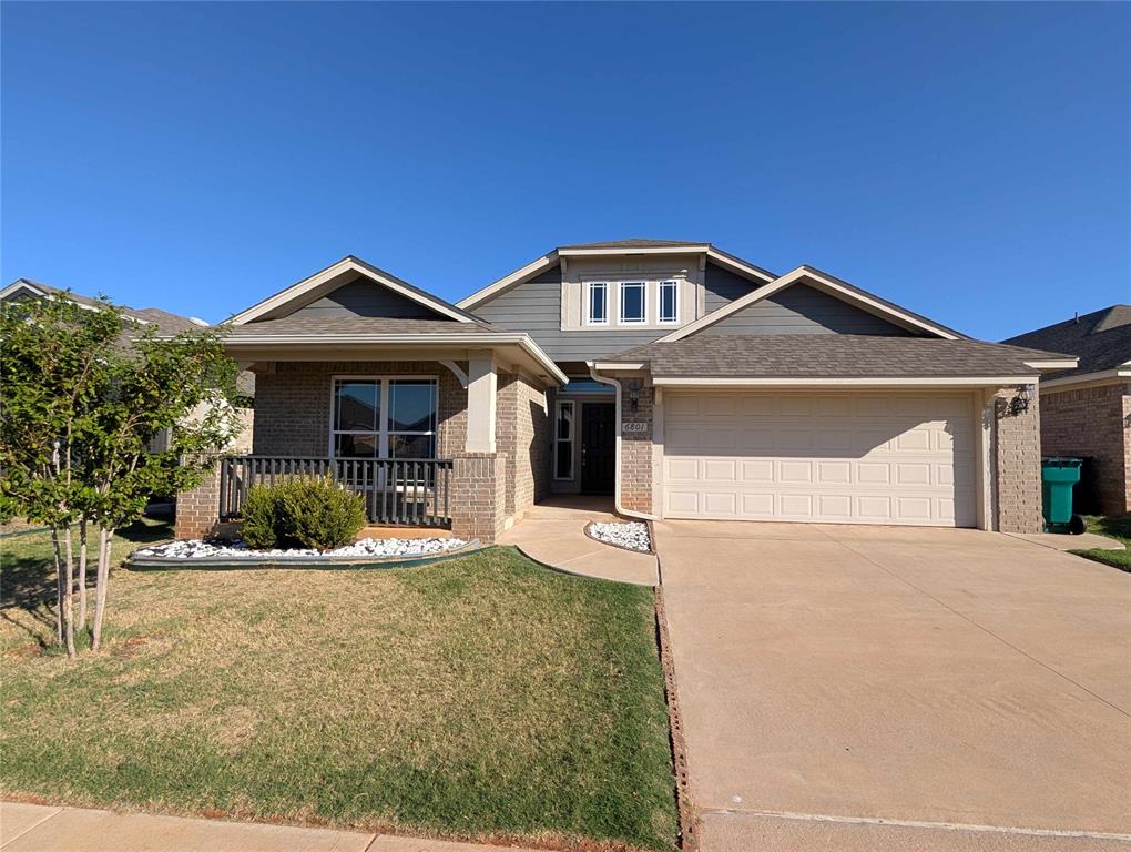 Welcome to this beautiful Edmond home featuring a spacious open layout and modern finishes throughout. The main living area offers wood look tile flooring, high ceilings, and plenty of room for relaxing or entertaining. The kitchen features a large center island, quartz style countertops, two tone cabinetry, subway tile backsplash, stainless steel appliances, and ample cabinet space. A separate dining area provides additional space for everyday meals or gatherings. The spacious primary bedroom features a vaulted ceiling, ceiling fan, and private bathroom with a large vanity, soaking tub, separate shower, and walk-in closet. Additional features include a covered front porch, attached two-car garage, and neutral finishes throughout. Conveniently located near shopping, dining, and everything Edmond has to offer. Schedule your showing today!