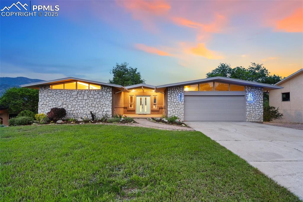 Welcome to this one of a kind west side home, where luxury living meets breathtaking views—easily some of the best in all of Colorado Springs. This fully remodeled 4-bedroom, 3-bath home offers 2,602 square feet of refined style, perched on an impressive 12,204 sqft lot.  Step inside and enjoy luxury vinyl plank flooring and custom lighting throughout, creating an upscale and modern feel. The living room is a true showstopper, featuring a custom stone wood-burning fireplace, LED lighting on dimmers, a handcrafted stair rail, and a walkout to the expansive deck—perfect for taking in those iconic mountain and Garden of the Gods views.  The kitchen is sleek and sophisticated with quartz countertops and stainless steel appliances. The master suite is its own private retreat with deck access, a walk-in closet, and a spa-like ensuite with ceramic tile, high-end fixtures, and a night light for added comfort. 
 Upstairs, one of the bedrooms boasts vaulted ceilings with custom LED lighting, while the adjacent bathroom offers a floating sink, ceramic tile, and more luxury finishes. Head to the walkout basement to find a cozy second stone fireplace, luxury carpet, and clever understairs storage. Downstairs bedrooms include a walk-in closet and panoramic mountain views, and the bathroom features a stylish stand-up shower and ceramic tile.  With thoughtful upgrades at every turn and views you simply can’t beat, this home is one-of-a-kind. Don’t miss your chance to make it yours!