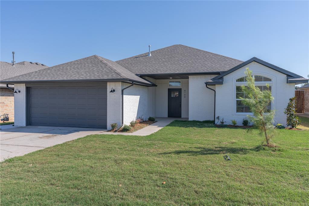 Welcome to this brand-new, move-in-ready 3-bedroom, 2-bathroom home in the excellent Moore School District, offering an unbeatable location with easy access to I-240 and just minutes from Lake Stanley Draper. This home features a great open layout, with a large living room bathed in natural light from generous windows and anchored by a cozy corner gas fireplace. The space flows seamlessly into the eat-in kitchen, which is both stylish and highly functional, boasting white painted cabinetry, quartz countertops, a trendy tiled backsplash, stainless steel appliances, a large farm sink, floor-to-ceiling cabinets, and a dedicated pantry closet. The private primary suite features a stylish barn door entry to the en-suite, complete with dual vanities, a beautifully tiled soaker tub surround, a walk-in shower, and a large wrap-around closet. Built-in linen storage in the hallway and spacious secondary bedrooms that share a large full bath complete the interior. Outside, enjoy the spacious yard and covered patio, perfect for relaxing or entertaining.