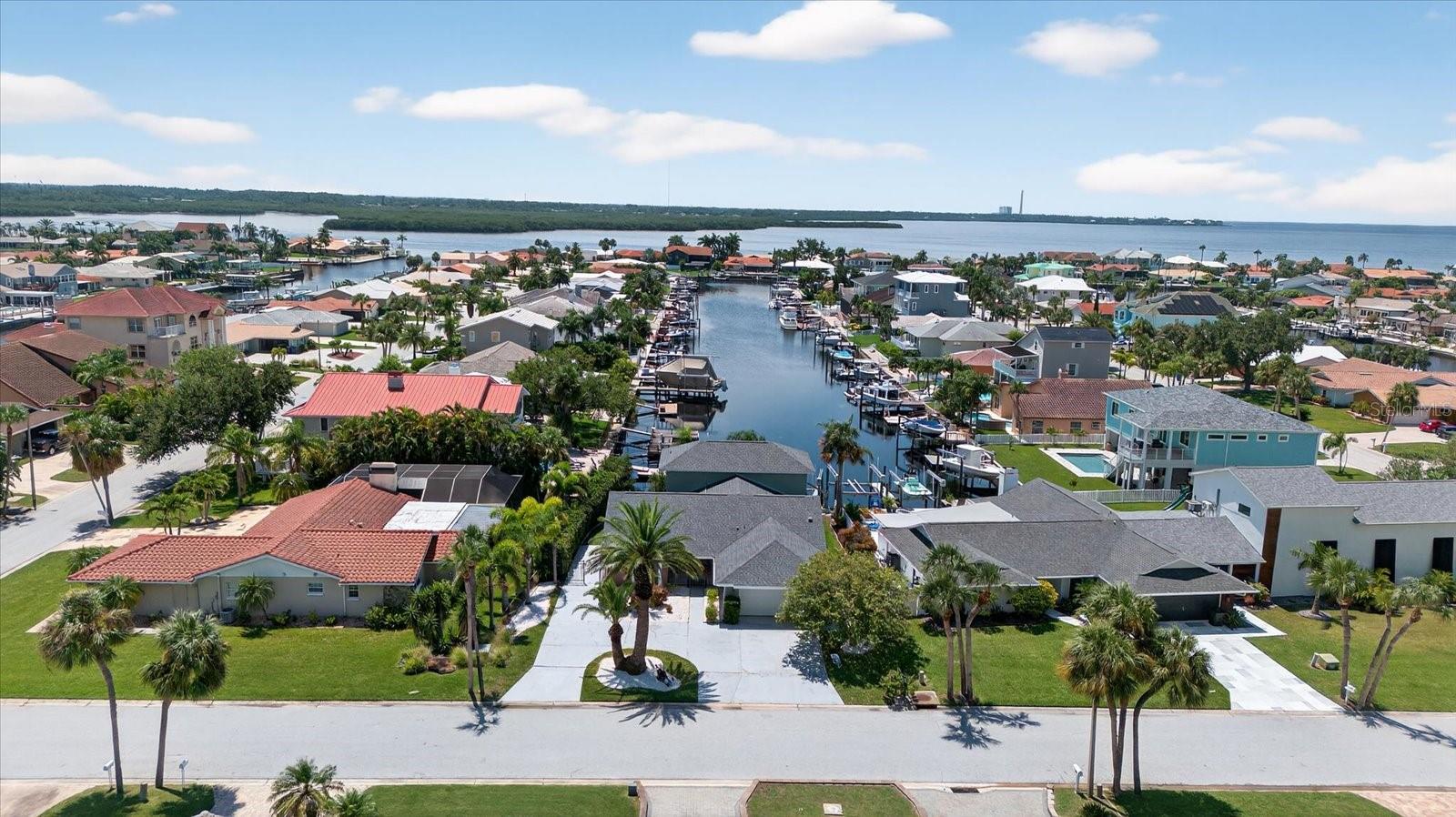 Picture yourself in a tropical oasis, where lush landscapes and serene canal views create your private retreat in this stunning 3-bedroom, 3-bathroom Gulf Harbors’ home featuring a 10,000 pound boat lift and quick, unobstructed access to the Gulf!  With 2,244 square feet of coastal charm, this 2 story home offers long water views from every corner. Set sail right from your backyard with deep-water Gulf access, the 10,000 pound boat lift, and space for a pool. The home features two primary suites—one on the main level with a walk-in closet and en-suite, and a secluded second-floor suite with a private loft overlooking the tranquil waters. This gorgeous home was completely remodeled after the storm including new kitchen with custom cabinetry, stainless steel appliances, acres of countertop and eat-in kitchen area, all open to the expansive great room. Double sliders and a large picture window create a light and bright atmosphere to enhance the gorgeous water views. 

Downstairs, you’ll find 2 large bedrooms and 2 baths, and a spacious, sweeping great room. Upstairs you’ll find the second primary suite featuring a loft area with an awesome view that would make a perfect home office, yoga or sitting room, a large bedroom with walk-in closet and a spacious bathroom.  

Solar panels, installed in 2019, come with a 15-year transferable warranty and a 25-year lifespan, ensuring a light energy footprint and an electric bill as low as $30.00 a month. A new roof was installed in 2018. One hot water heater was replaced in 2022, and the second in 2025. The home is fully fenced with room on the side for boat or trailer parking. There is a yearly termite bond.  Additional features include a Ring doorbell and a Nest thermostat. There are two AC units, installed in 2019 and 2021. This property is a boater's paradise with a 10,000-pound boat lift installed in 2019 by Water Ventures, floating dock with composite Trex decking, and davits for your adventures. 

Whether you're entertaining in the expansive living spaces, retreating to one of the primary suites, basking in spectacular sunsets, or letting the dogs out for a run, this home captures ALL the essence of the Florida coastal lifestyle. 

Located in one of Pasco's finest waterfront communities on a quiet street ending in a cul-de-sac, this home also features underground utilities, and is a great walking neighborhood. Optional membership to your gated private beach club is available for just $200 a year, offering stunning sunsets nightly, and equipped with covered gazebos, picnic tables, bathrooms and grills to make your beach trip the best! The neighborhood is also golf cart-friendly and has a lot of events and parades to entertain you or involve you throughout the year. For boating enthusiasts two community ramps are available, with a key available for purchase through the Gulf Harbors Civic Association.  The Association offers an OPTIONAL HOA membership for only $125 a year. This home has an existing ASSUMABLE FLOOD INSURANCE POLICY! Your boating adventures begin with a 4 minute run to the Gulf with access to the Intercoastal Waterway and Anclote barrier island, which has stunning lighthouse views and some of the best shelling around! 

Gulf Harbors is also conveniently close to downtown New Port Richey's top attractions. Less than 10 minutes to Sims Park or your favorite restaurants and shops. Find your slice of Paradise here at 3358 Seaway Drive today!