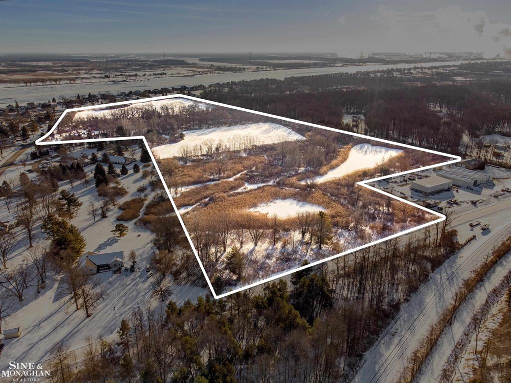 This 50.07-acre parcel offers an exceptional opportunity for development or investment, situated in a prime location with road frontage on three different roads. One of the last remaining large tracts in the area, it provides easy access and potential for various uses. The St. Clair River is within sight, enhancing the property's appeal with scenic views and proximity to water. While the land is currently undeveloped, an old house and barn are included in the sale, though the house is not accessible. Don't miss the chance to own one of the area's most sought-after properties!