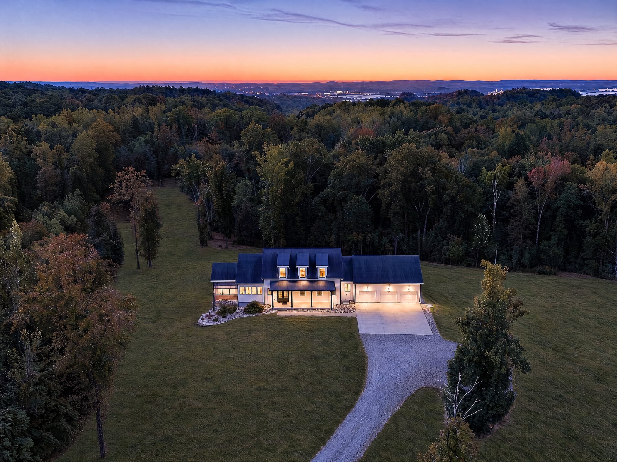 Tucked away from the world in a peaceful, and expansive setting, this beautiful retreat offers privacy, space, and natural beauty. The entire 34-acre property has a perimeter fence and trail that can be used by a UTV and features two natural springs, a network of trails, and picturesque rolling terrain, creating an ideal setting for horses, hiking, exploring, farming or simply enjoying the serenity of the outdoors - The modern farmhouse is custom built, featuring expansive windows that frame beautiful views of the surrounding countryside filling the home with abundant natural light. Inside, an open floor plan offers generous living and entertaining spaces, beautiful hardwood floors, and a spacious kitchen that flows into the dining and living areas. The main-level primary suite provides privacy from the additional bedrooms below and recreation spaces offer exceptional flexibility for family, guests and entertaining. An expansive multi-use third-floor is perfect for a bunk room, designated office space, art or yoga studio. The fully finished walk-out basement features high ceilings, the additional three bedrooms, a game room, additional living room and a large 33x7 poured concrete safe room that can double as an incredible wine cellar. - Whether you're dreaming of a horse property, a private recreational retreat, or simply a peaceful place to call home, this one has it all. Explore trails that meander through the tranquil woods, watch your horses run, or unwind on the covered deck surrounded by nature. The property's gentle rolling terrain creates a landscape that feels worlds away from the everyday. *Property also benefits from the greenbelt tax credit.*