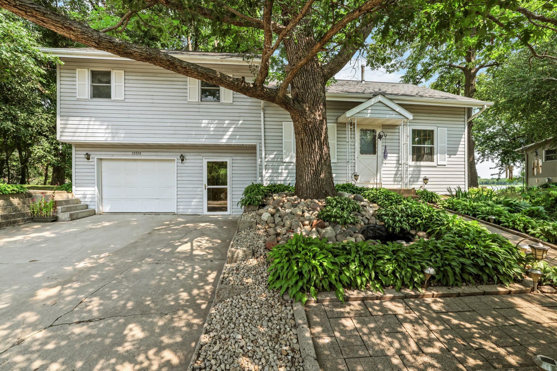 Enjoy Lake Living at Ida Lake! Ida Lake is a beautiful lake known for excellent fishing and a variety of recreational opportunities. This home is conveniently located approximately 30 minutes west of the Twin Cities metro area. Whether you’re looking for a place to relax, fish, boat, or enjoy time with family and friends, this is a great opportunity to own lake property. This charming 3 bedroom, 3 bath home is situated on a beautiful double corner lot with a lovely landscaped yard. The spacious owner’s suite offers a private full bath, walk-in closet, and beautiful lake views. Step outside and enjoy the large backyard deck that is perfect for relaxing, entertaining, and taking in the lakefront setting. The property offers plenty of additional storage with three sheds, providing ample space for lake toys, tools, and outdoor equipment. Numerous updates have been completed.  The updates include a new furnace in 2019, a new well in 2021, new drain tile in 2012, a new water softener in 2021, and a pressure tank was installed in 2021.  With its generous lot, lake views and outdoor entertaining space, this property offers an opportunity to enjoy lake living.