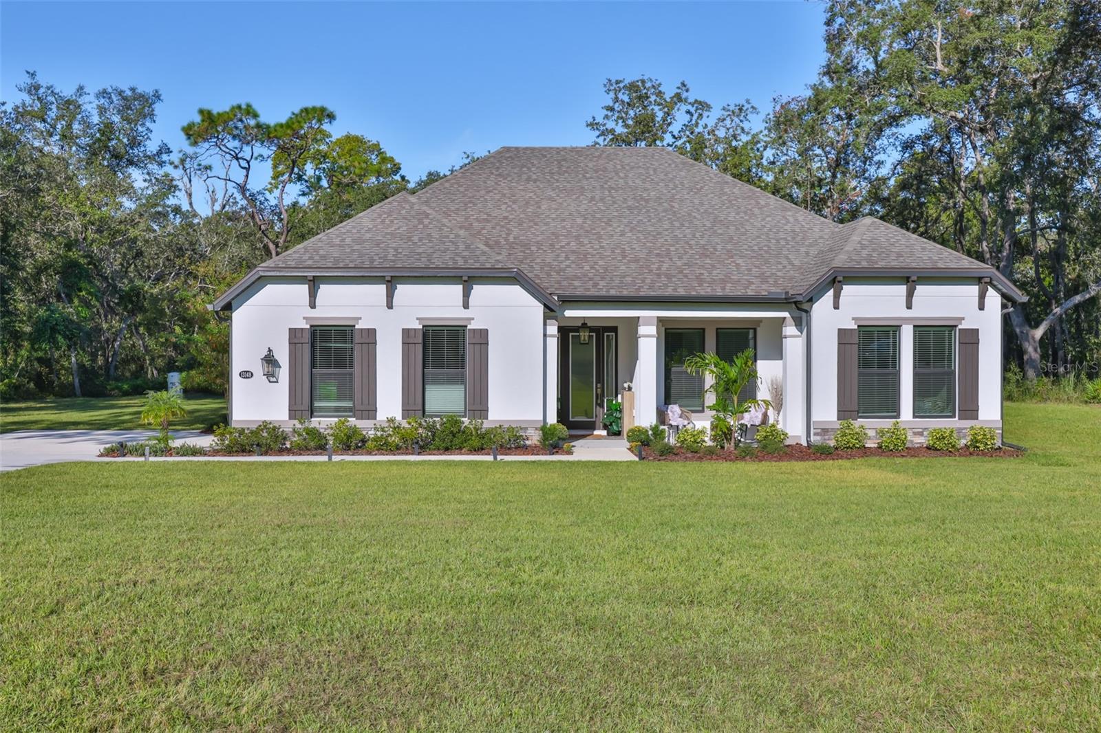 Experience the perfect blend of space, privacy, and luxury living in the highly sought-after community of Bella Terra in Hudson, Florida. Situated on an expansive 2.39-acre lot, this stunning 4-bedroom, 2-bathroom home offers 2,672 square feet of beautifully designed living space surrounded by peaceful natural scenery.Step inside to discover an open and inviting floor plan featuring spacious living areas, abundant natural light, and thoughtfully designed finishes throughout. The oversized kitchen is ideal for entertaining, offering ample cabinetry, generous counter space, and seamless flow into the main living and dining areas.The primary suite provides a private retreat with a spa-like bathroom and plenty of closet space, while the additional bedrooms offer flexibility for family, guests, or a home office setup.Outside, enjoy the tranquility and privacy of your oversized acreage lot with endless possibilities for outdoor living, recreation, or future customization. Located in the beautiful gated community of Bella Terra, residents enjoy a serene setting while remaining conveniently close to shopping, dining, schools, and the Gulf Coast lifestyle.This is a rare opportunity to own a spacious estate property with room to grow in one of Hudson’s most desirable communities.