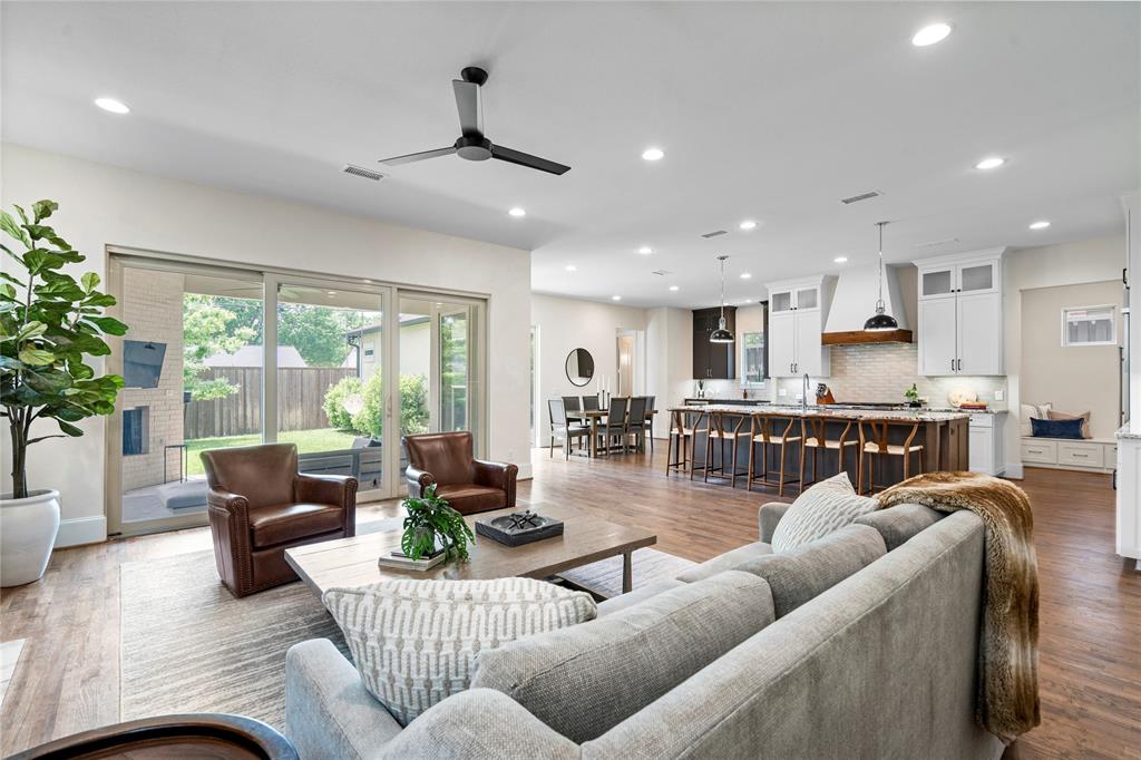 Designed and built by acclaimed D Magazine Best Home Builder David Goettsche of Desco Homes, this exceptional residence is a masterclass in timeless design, thoughtful functionality, and refined luxury! Meticulously crafted and impeccably maintained, this home offers over 4,000 square feet of beautifully appointed living space with a flexible layout to accommodate both intimate everyday living and elegant entertaining. Natural light pours through dramatic floor-to-ceiling windows, highlighting the home’s clean architectural lines and seamless connection to the outdoors. The versatile floor plan features dual primary suites on the first and second levels—each offering spa-inspired ensuite baths complete with freestanding soaking tubs, oversized walk-in showers, and custom-designed closets worthy of a boutique. At the heart of the home, the chef’s kitchen is a statement in sophistication and performance. Anchored by a massive white granite island, it boasts a full suite of KitchenAid Professional appliances including a built-in refrigerator, 6-burner gas cooktop, double ovens, and pro-style vent hood. Dual walk-in pantries and a butler’s pantry with a bar sink provide abundant storage and seamless flow for entertaining. The main level offers a formal dining space that easily transforms into a study or private office, while the expansive upstairs media and living area—with its dedicated wet bar, beverage fridge, & built-in coffee station—offers the perfect retreat for relaxation or hosting guests. Additional highlights include generous storage throughout, a beautifully integrated outdoor living area, and an enviable location just minutes from the best of popular East Dallas shopping, fine dining, White Rock Lake and convenient to downtown Dallas. Located in sought-after Wilshire Heights neighborhood and zoned to the award-winning Mockingbird Elementary, this home effortlessly blends architectural excellence with an unparalleled lifestyle.