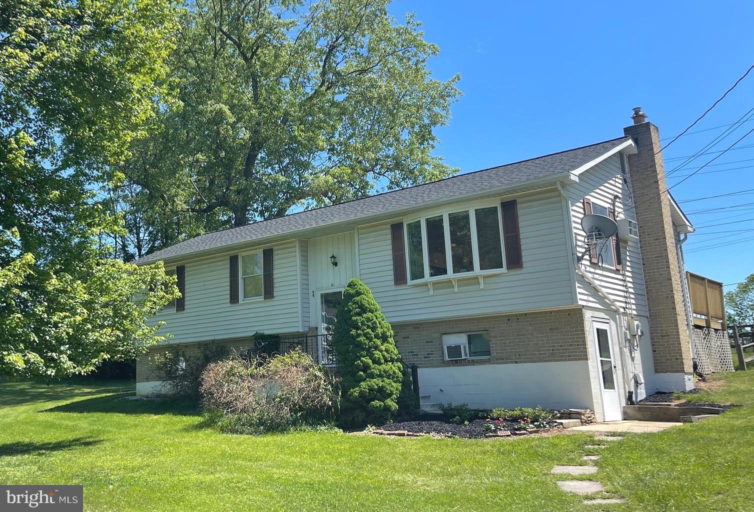 Holiday Price Reduction!!!  This charming split-level home rests on nearly half of an acre at the end of a cul-de-sac within five minutes of downtown, historic Shepherdstown!  Hardwood flooring runs throughout the living areas on the main floor including the living, dining and kitchen spaces while large windows throughout provide an abundance of natural light.  The main living area transitions to the hallway with three bedrooms along with one full and one half bathrooms.  An additional full bathroom is located on the lower level!!! This lower space also provides additional finished living room; currently used as a second primary sleeping area. The multiple windows provide natural light while the full glass door leads to a level walk out side entry.  A long paved driveway provides plenty of off street parking.  Enjoy restful evenings grilling on the long rear deck or relaxing in the partially fenced-in backyard. Recent upgrades include a NEW ROOF in 2024, along with new refrigerator, microwave, and water heater in 2025!! Don't miss this adorable home, tucked away at the end of the cul-de-sac and ready for a new owner!