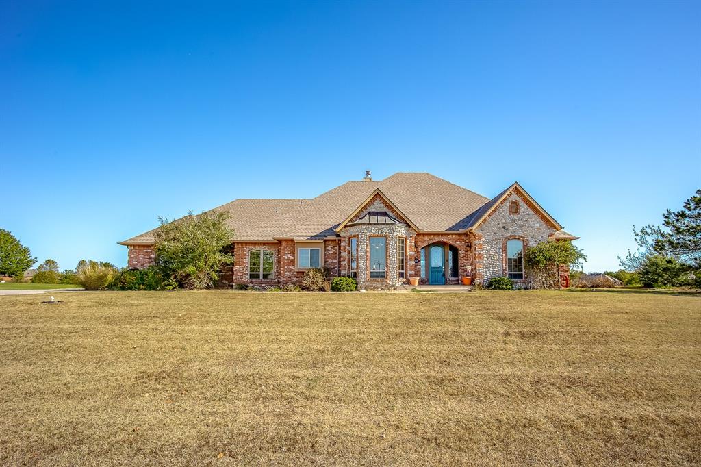 Enjoy a peaceful waterfront setting with a country feel and convenient access to Norman via Highway 9. Situated on 1.39 acres in gated Wellington Lake, this single-story home offers an unusual combination of comfortable living spaces, scenic surroundings, and an enclosed Endless Pool designed for year-round swimming and exercise. The thoughtfully arranged floor plan features three bedrooms, each with its own private full bathroom, plus an additional half bath. The spacious living room features wood flooring, a fireplace, and views into the adjoining pool room. A dedicated study with built-in bookcases provides a comfortable workspace, while the formal dining room, kitchen with center island, and breakfast area offer inviting spaces for everyday living and entertaining. The Endless Pool features a current-generating system that allows swimming in place, making it ideal for exercise and aquatic fitness. Its enclosed pool room has a dedicated HVAC system, expansive windows, French doors, and additional space for relaxing or entertaining. The 961-square-foot pool room is not included in the home's reported living square footage. Outside, the spacious homesite offers waterfront views and room to enjoy the peaceful surroundings. Additional features include an attached three-car garage, an in-ground storm cellar, a large decked attic storage area with a Versa-Lift system, a recent roof replacement, newer HVAC equipment, and a tankless water heater. Located in the Noble School District, Wellington Lake offers gated entry and a quiet setting just a convenient drive from Norman's shopping, dining, and everyday amenities.