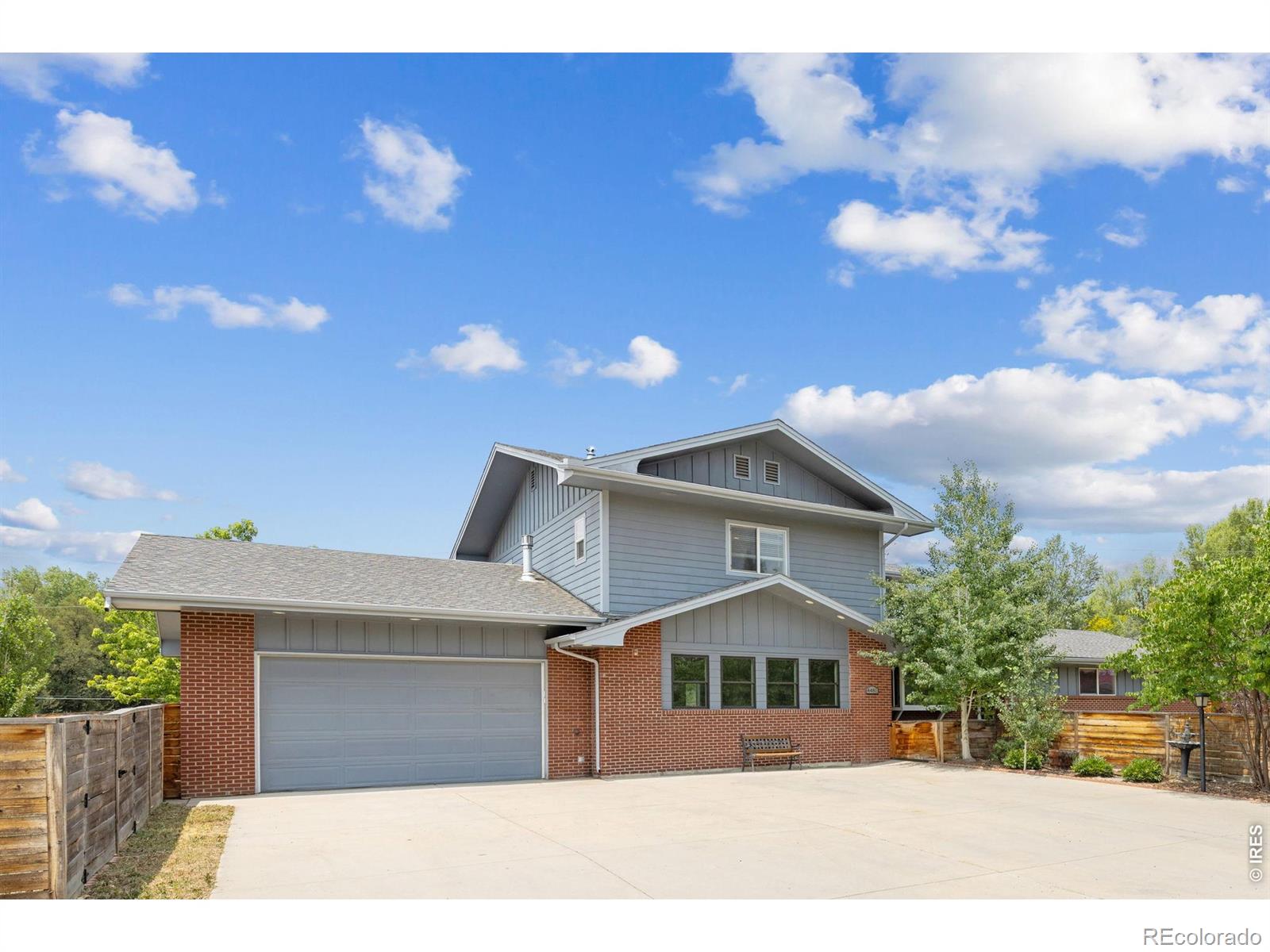 Expansive home on a peaceful near-acre with Flatiron views in the charming Juhls neighborhood in northeast Boulder. The private yard includes fruit and shade trees in the front and side yards, while the open rear yard offers far-reaching views and ample space for pasture or play. This 4-bedroom + office, 5-bathroom ranch home with an upper-level private primary suite that offers dual closets, in-floor radiant heat, a laundry room, a rooftop deck, and a separate entrance for ADU or an in-law potential. The main level includes two additional bedrooms, two bathrooms, an office, kitchen, and living room, plus a newly completed family room with a linear fireplace, built-in TV, and custom cabinetry - perfect for hosting or settling in for movie night. A mudroom off the garage adds a second W/D hookup, a custom dog bath, and a washroom. The oversized garage itself - nearly 800 square feet with 10-foot ceilings and climate-controlled - is ideal for the craftsman or hobbyist. A separate storage shed keeps lawn equipment and outdoor toys tucked away. The lower level offers an additional bedroom and bath, a large rec room flex space, and plenty of storage. Recent investments include new fencing, yard grading and irrigation, French drains and hardscaping, new flooring, a new hot water heater, and a ductless mini-split for the southern rooms - alongside the completion of the new family room as the first phase of a permitted main level renovation. Enjoy lower sales and property taxes by living in Unincorporated Boulder County, along with the freedom and flexibility of NO HOA. Architectural plans and permits transfer to the new owner to continue this vision, or bring your own ideas; site plan review also allows for an expanded mezzanine and entryway, giving this special property the welcoming facade it deserves. Come see for yourself the views and potential for this home Sunday, June 28th, 11 a.m.- 1 p.m.!