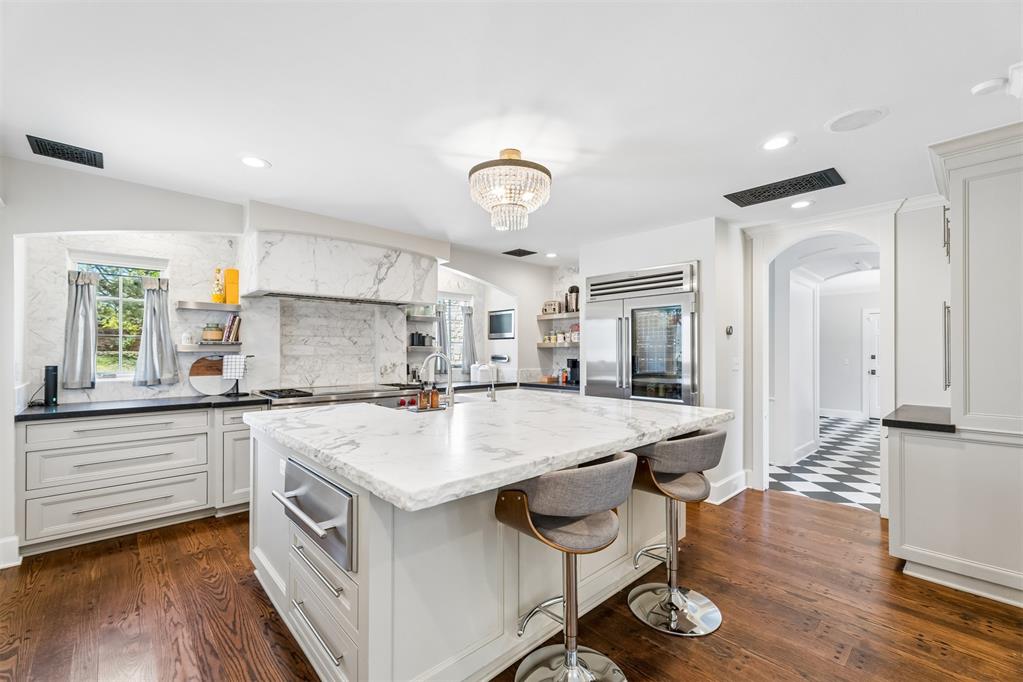 Looking for a Nichols Hills Estate at an affordable price, then your search is complete.  Come tour this move in ready home on sought after Elmhurst Avenue!  This Raymond Carter and Carson Sees design residence has the perfect blend of luxury, style and space for growing families.  The kitchen is equipped with a 60" Wolf range, a Sub-Zero refrigerator/freezer and an impressive calcutta marble island.  Also featured is a designated dining room, a traditional formal living room as well as an attached pool cabana and game room, perfect for family fun and entertaining.  The spacious primary suite has a cozy fireplace and his and hers bathrooms and closets.  Another special feature is the expansive upstairs theatre/game room, providing a dedicated retreat for the kids.  Venture outside and enjoy the pool/hot tub and spacious backyard for more relaxing leisure time.  A spacious three car garage with an above ground safe room complete this amazing property.  With close proximity to the Oklahoma City Golf and Country Club and private schools, this residence offers an easy living lifestyle that many families are seeking to find!