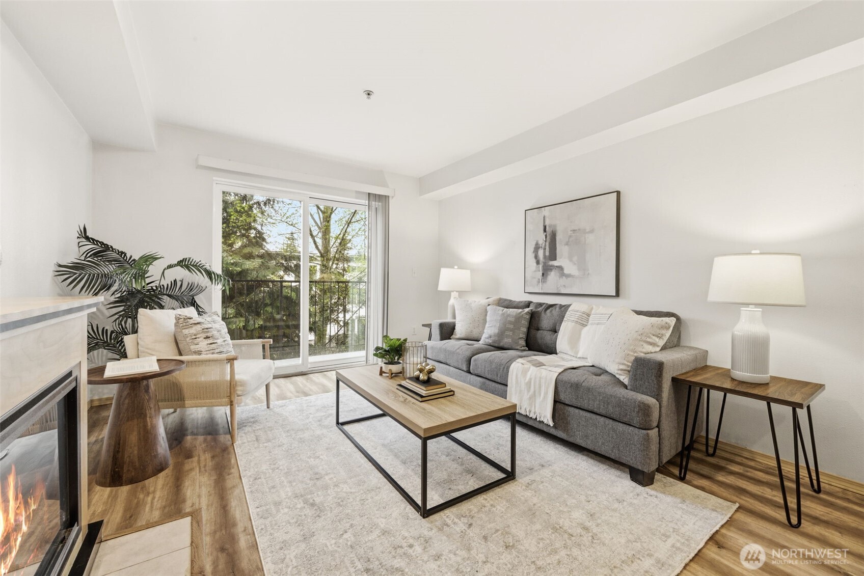 Pristine condo in the heart of Greenwood offers a private oasis amongst a verdant backdrop of foliage. Just two blocks from the new Trader Joe's and walking distance to everything Greenwood and Phinney Ridge have to offer, this one-bedroom home is a must see. Tucked off the main street in a park-like setting, dine al fresco on the expansive covered deck while listening to the birds, or enjoy cozy evenings around the fireplace. Entertain with a dining area large enough to accommodate a full-size dining table, or enjoy one of the many neighborhood restaurants and cafes this special neighborhood has to offer. Complete with a washer and dryer, secure garage parking with bicycle storage, a well-run HOA, great public transportation and nearby cycling routes, this beautiful condo offers the very best of Greenwood-Phinney living!