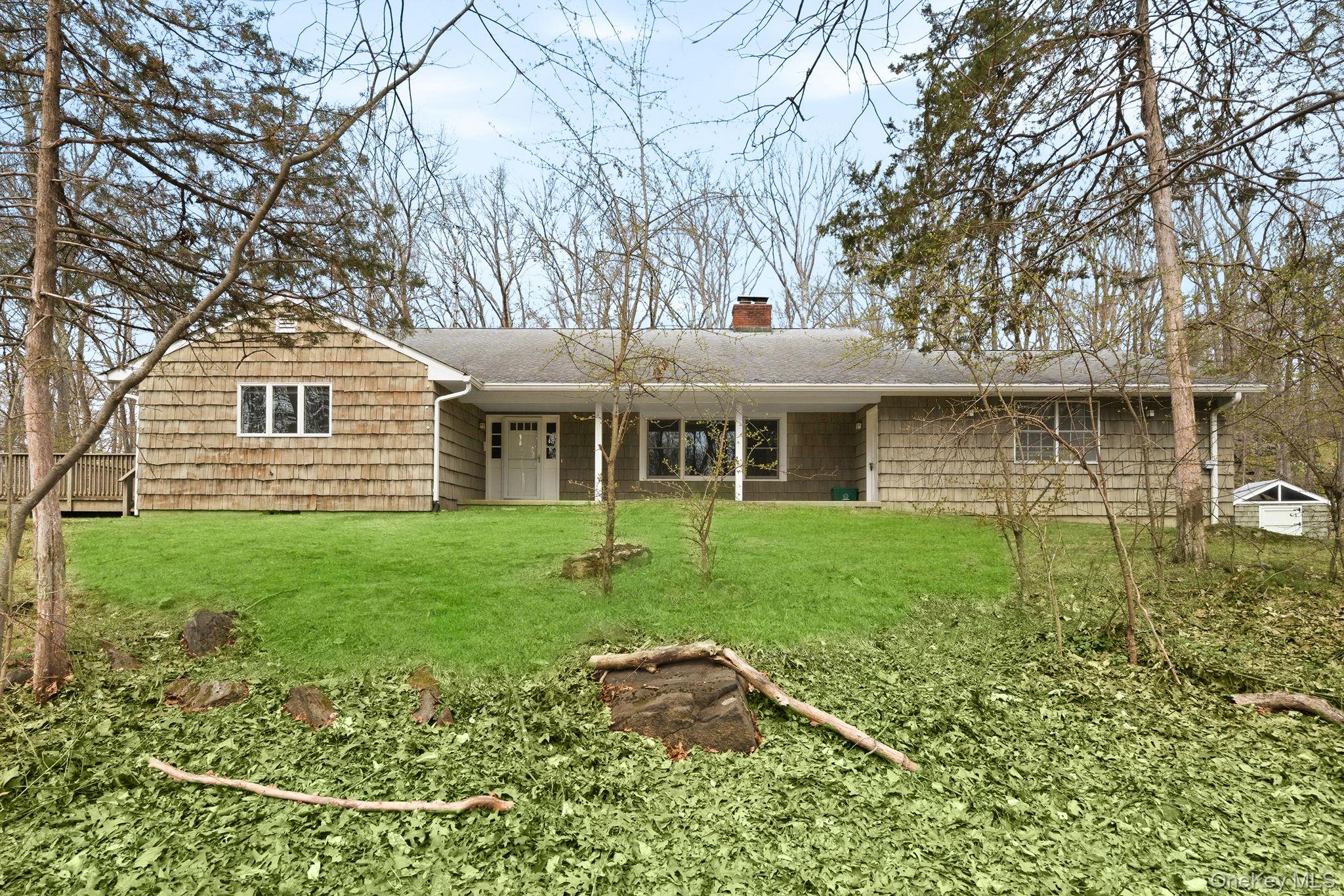 Tucked away on over 4.3 private, wooded acres on Croton Lake Rd in Yorktown, this carefully maintained split-level home offers the perfect blend of privacy, comfort, and convenience. With approximately 2,280 sq ft of living space, this serene residence features 3 bedrooms, 2 full baths, and 2 half baths, and 2 car garage, thoughtfully designed for both everyday living and entertaining.Sunlight pours through abundant windows, highlighting the warm wood floors and inviting interior. The updated kitchen boasts stainless steel appliances and flows seamlessly onto the large deck via the slider door. Enjoy cozy evenings by one of the two fireplaces, or gather with friends and family on the expansive deck, perfect for outdoor entertaining surrounded by nature and beautiful birds and wildlife.Additional highlights include a finished basement with a fireplace offering flexible living space, central vacuum system, energy-efficient heat pump with A/C, and a standby generator for peace of mind. In addition, the basement has a half bath and a separate laundry room with plenty of storage and slider and door to backyard.  Set back on a long private shared driveway, this home provides a tranquil retreat with a beautiful wooded backyard and mature trees.Ideally located just minutes to town, schools, shopping, dining, and major conveniences including BJ’s, Trader Joe’s, Lowe’s, and easy access to the Taconic State Parkway, this home delivers the best of both privacy and accessibility.A rare opportunity to own a serene, spacious property in a prime Yorktown location—don’t miss it