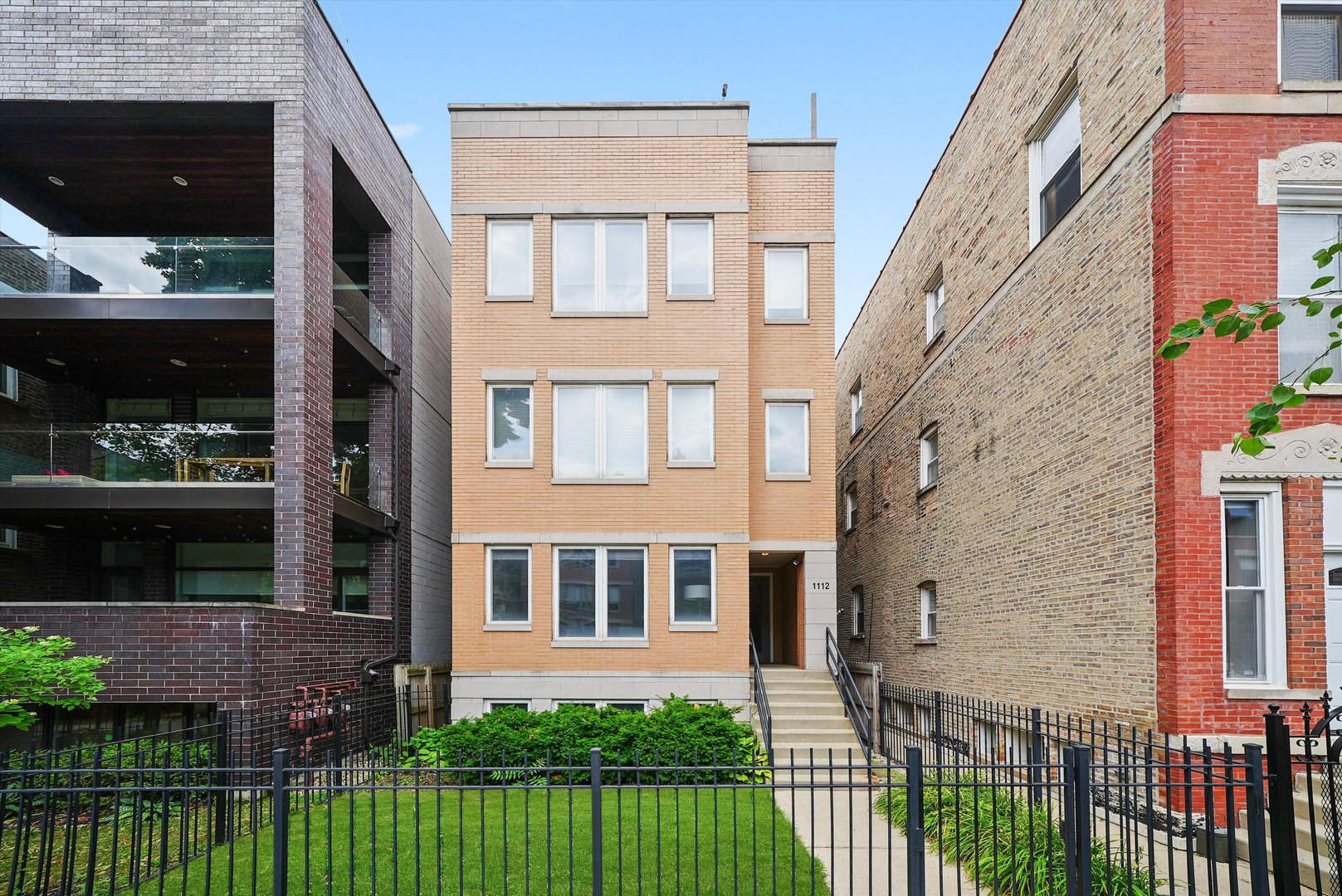 Welcome to single-family living-inside a condo! This stunning 3 bed / 2.5 bath, duplex-down is on a tree-lined street just steps from Division Street in the heart of Wicker Park. The main floor features a spacious and sun-filled living area loaded with upgrades: a renovated kitchen with a new sink, quartz countertops, designer fixtures, Hudson Valley island pendant lighting, a new Cafe refrigerator and matching Cafe oven/range, and a striking floor-to-ceiling fireplace. The open-concept layout is perfect for entertaining, offering room for a large dining table plus seating at the oversized island. You'll love the additional dry bar, complete with extra countertop space, and a beverage/wine fridge-perfect for hosting. Just off the kitchen is a stylishly refreshed powder room. The rear of the main level is home to a luxurious primary suite, boasting a wall of closets and a updated ensuite bath with dual vanities, a jetted soaking tub, and a walk-in shower. Step out onto your private deck-ideal for a quiet morning coffee or a relaxing afternoon read. Downstairs, spread out in a generous second living area-perfect for movie nights or gaming. This level also includes the second bedroom with direct access to a full bath, and a newly constructed third bedroom. Need storage? You'll find another wall of closets and an interior storage room-no need to access a shared hallway. A detached garage parking spot is included. Enjoy the best of city living with walkable access to everything Wicker Park has to offer.