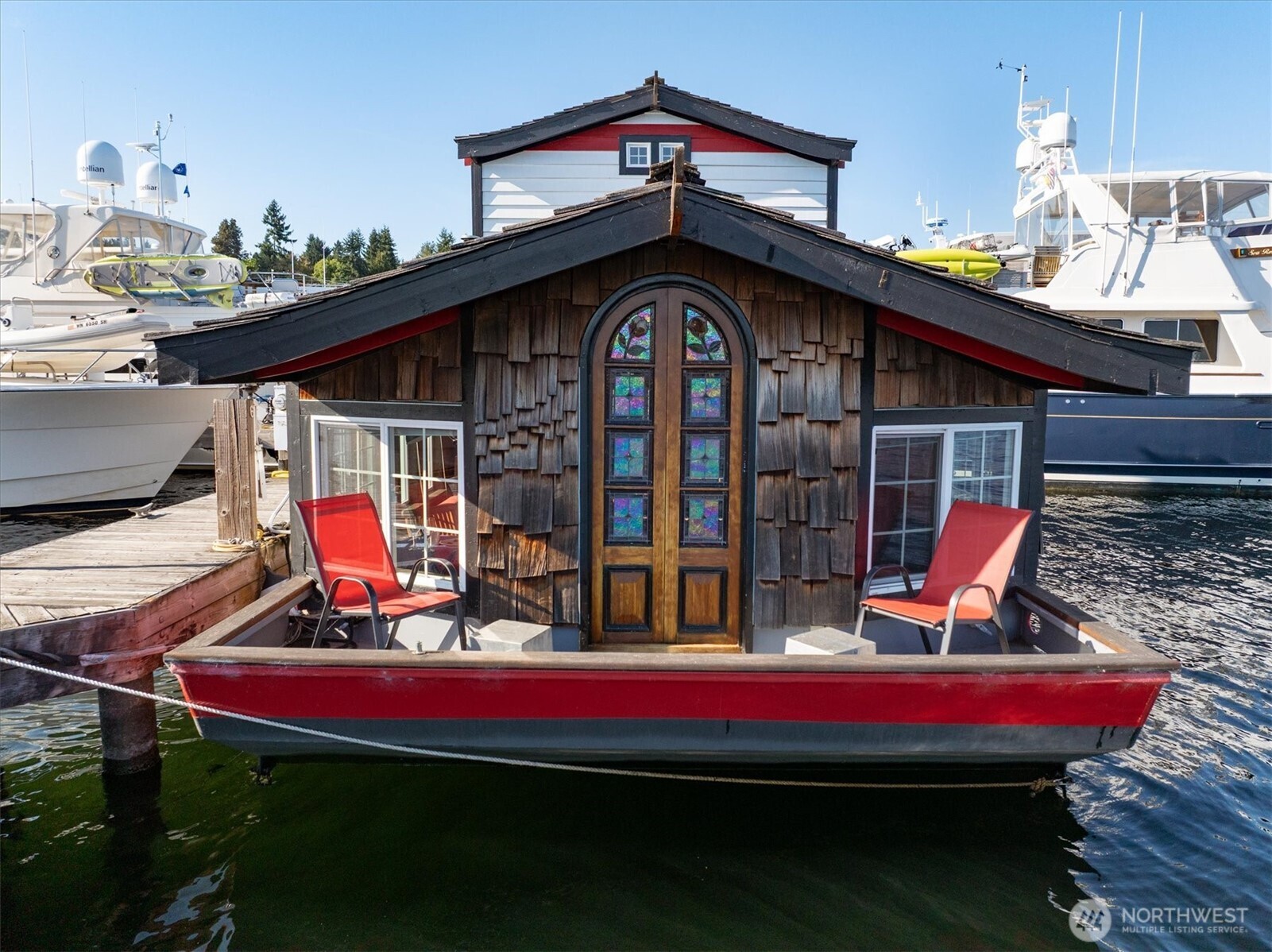 Uncompromising Lake Union views & intelligent design combine to create the ultimate in houseboat living.  Easy water access with the last slot on the dock, you’ll find no end of both city views and unrestricted lake vistas. Step into this houseboat & find the perfect gathering spot with a wide interior,  a thoughtful kitchen w/all the fixings & impressively vaulted ceilings throughout. A barn door leads to a ¾ bathroom, and the spacious living room offers easy deck access through artful stained glass doors. Upstairs, find a welcoming bedroom, complete with a large closet. Offering a perfect location with easy Marina parking (you’re just minutes from downtown Seattle, lake-centric recreation, and more), this houseboat is home sweet home.