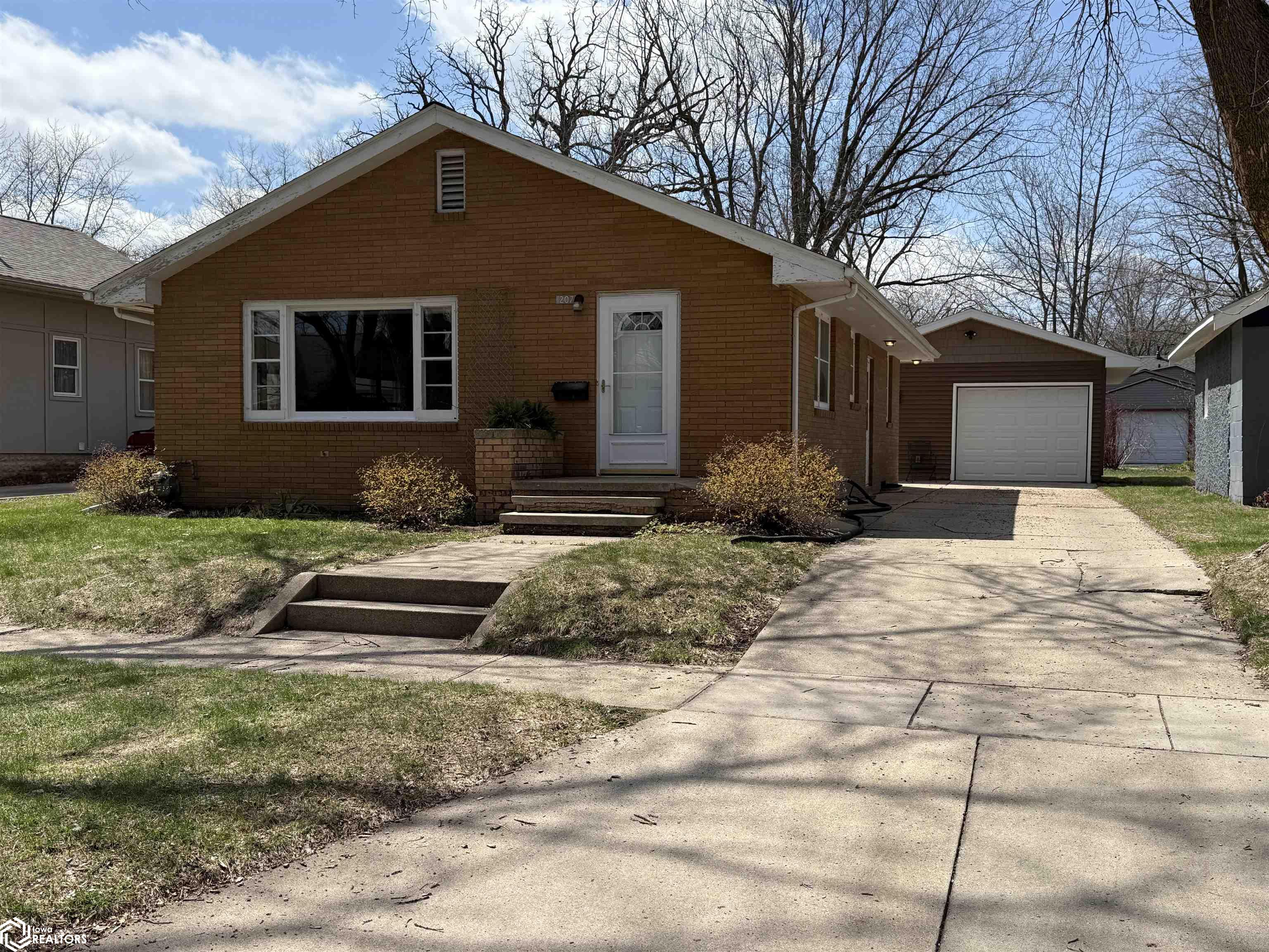 Welcome to this delightful brick home, brimming with character and ready for your personal touch. Owned by the same family for nearly its entire life, this well-loved home is ideally located just two blocks from the Clear Lake Aquatic Center and park—and a short stroll to vibrant downtown Clear Lake.  Inside, you’ll find two bedrooms with original hardwood floors and a spacious, expanded living room—perfect for relaxing nights in or family gatherings.   The kitchen features warm Woodharbor maple cabinetry along with a stainless steel refrigerator, providing a solid foundation for your dream culinary space. A walk-in shower offers modern comfort, and the full basement includes a washer and dryer, plus ample room for storage or future finishing ideas.  A newer detached garage—accessible from both the driveway and alley—adds valuable versatility and ease.  Whether you're searching for a charming home or a creative project to make your own, this inviting property is a blank canvas full of opportunity. Call your favorite realtor today to set up a showing!