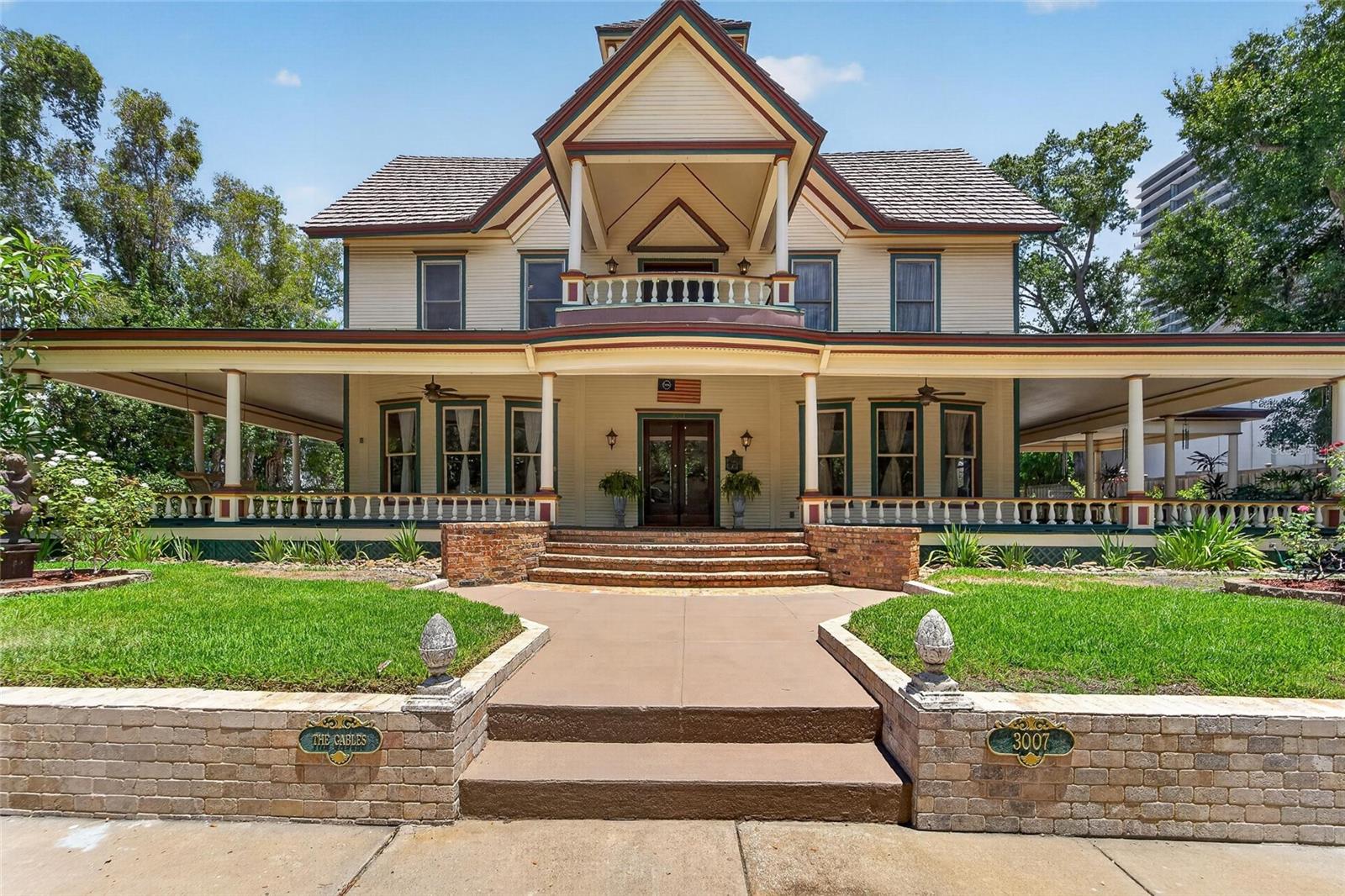 Welcome to a Breathtaking Gem of South Tampa—one of the Oldest Homes in the City, built before 1900 and brimming with timeless charm. As you step through the Double Front Doors, you are greeted by a Grand Foyer—a Classic Centerpiece that offers a sweeping view of all the Downstairs Rooms. Spanning over 4,800 square feet, this classic residence features Soaring 15-foot ceilings. Throughout the Home Wood Floors run Underfoot, with 10 Inch Baseboards and Crown Molding Highlighting each Room.  Rich Woodwork defines every detail—door frames, window frames, pocket doors, baseboards, and chair rail—all crafted from maple and pine. In the Eat-in style Kitchen, Elm Wood Cabinets line the space above and beneath Quartzite Countertops, all set beneath a stunning Copper-toned Ceiling Design. A Ceramic Sink, Elmira Gas Stove and Stainless Steel Appliances complete the Culinary Haven, along with a Walk-in Pantry. Pocket doors lead to expansive formal living, dining, and family rooms, each anchored by one of five fireplaces. From the Foyer, a Beautiful staircase ascends to a wide, elegant Hallway upstairs, adorned with chandeliers and bathed in Natural Light, while not a foyer this expansive hallway leads you to all the upstairs  bedrooms, totaling four bedrooms and 2 baths in the Main house, Plus a detached one'bedroom, one-bathroom Apartment ( Freshly painted and new vinyl Floors)- for a total of 5 bedrooms and 3 Baths and from there, a Full Staircase leads to the Third floor Attic—a remarkable 2,000-plus square feet of unfinished space, ready to be transformed, bringing the total home size close to 7,000 square feet. The willow walk takes you to a top balcony sitting at the Peak of the Home, offering breathtaking views. Outside, an almost complete wraparound porch encircles a Tropical Garden Oasis, complete with a Spa/hotub with a waterfall, winding paths, water fountains and two garden sheds. Set on a rare third of an acre lot in South Tampa, with Two driveways and a Attached Carport plenty of parking for everyone. this home is just a block from Bayshore Boulevard and the vibrant town center—walking distance to restaurants, shops, and the beauty of the Bay—all preserved in its original