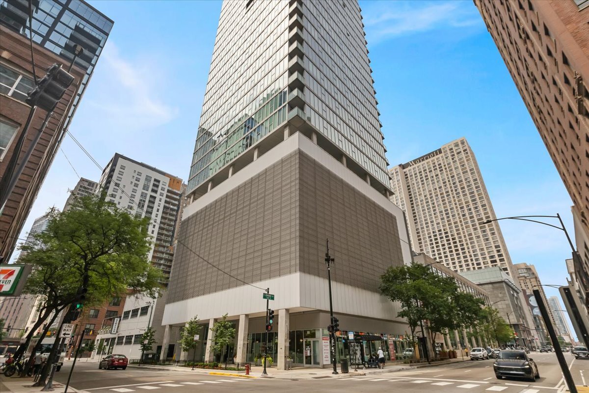 Experience contemporary elegance in this 3,200 sq. ft. penthouse-level residence in the heart of Streeterville. This light-filled home features 3 spacious bedrooms plus a versatile den/office, ideal for working from home or hosting guests. Enjoy a refined open-concept layout with modern glass walls, rich hardwood floors, and an ultra-sleek stainless-steel kitchen. Recently upgraded with smooth Corian countertops, an induction cooktop, and an extended island-perfect for entertaining or gathering with family and friends. Bask in panoramic city views from three exposures, a 47-foot private terrace off the living room, and a separate balcony off the primary suite. The custom-designed office space offers exceptional storage and built-ins to keep everything beautifully organized. Located in an intimate full-service building with 24-hour door staff, an indoor pool, sundeck, fitness center, and two heated side-by-side garage parking spots. Just steps to the lake, Michigan Avenue, shopping, and renowned dining-this is urban living at its finest.
