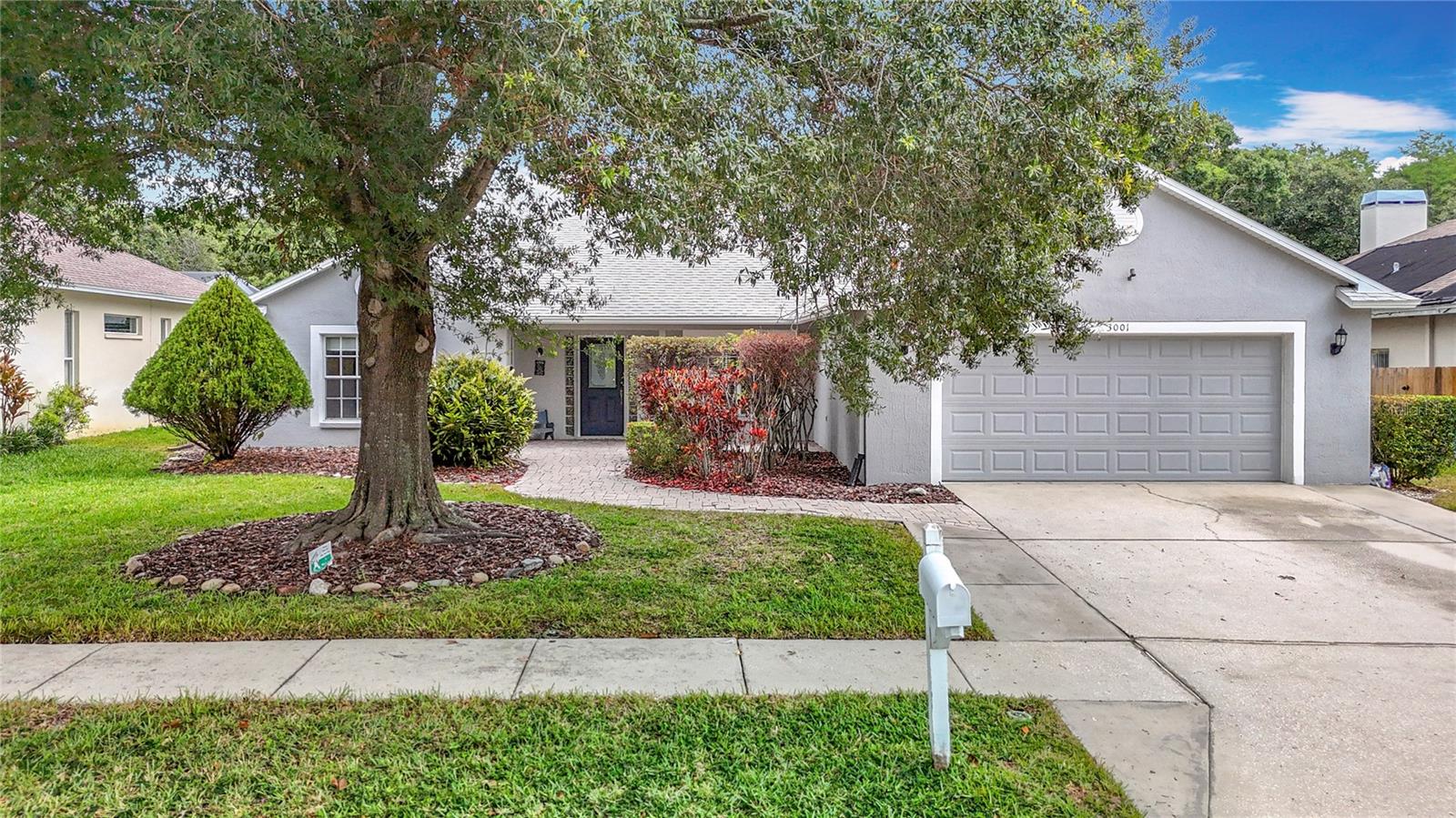 Tucked away in the peaceful, tree-lined community of The Groves at Cobbs Landing, this executive Palm Harbor home offers a rare combination of space, style, and tranquility. Featuring 4 bedrooms, 2 baths, a 2-car garage, and situated on nearly an acre of land, the property is ideally positioned with a pond view and protected conservation area, creating a private and natural backdrop for everyday living. Inside, you’re welcomed by an open layout with warm hardwood floors, neutral colors, accent ledges, and high ceilings that fill the home with natural light. The spacious living room features an elegant focal-point fireplace, while pocket sliding glass doors seamlessly extend your living space to the screened outdoor living area with a solar heated sparkling saltwater pool—perfect for relaxing or entertaining. Adjacent to the living room, the formal dining room includes a built-in dry bar/serving area, ideal for hosting guests. The kitchen is both functional and inviting, equipped with granite countertops, stainless steel appliances, a beverage cooler, and a breakfast bar that opens to the main living area—perfect for entertaining. A casual dining nook overlooks the pool, offering a relaxed setting for morning coffee or weekend brunch. The primary suite is a true retreat, featuring high ceilings, neutral tones, wood flooring, private access to the lanai, and a spa-like en suite bath with a jetted soaking tub, walk-in glass-enclosed shower, and a granite vanity with dual vessel sinks. Three additional bedrooms are generously sized, offering flexibility for family, guests, or remote work. The fourth bedroom, with double built-in closets and direct access to the primary suite, makes an ideal home office or nursery. Step outside to a beautifully brick pavered outdoor living space, where the solar heated pebble tec saltwater pool invites you to relax and unwind. The backdrop of the pond and conservation area enhances the home’s peaceful, private atmosphere—perfect for enjoying Florida’s indoor-outdoor lifestyle. Located near Lake Tarpon, zoned for top-rated Palm Harbor schools, and just minutes from shopping, restaurants, and entertainment—this home offers the best of both convenience and serenity. With its prime location, thoughtful layout, and natural surroundings, this is more than just a home—it’s a lifestyle. Welcome home!