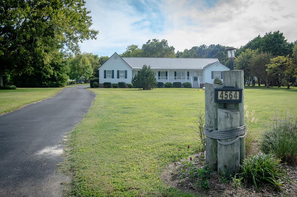 Countryside rancher in immaculate condition on generously sized 1.65 acre double lot on the corner of Seaside Rd & Capeville has open concept living w/ vaulted ceiling in living room/ dining area. Original home was a double wide.. owner expanded the original footprint w/ handsome additions including a in law suite suitable for visiting guests or family & a 16 x 12 screened porch overlooking well kept lawn and gardens. This is a virtually maintenance free home w/ vinyl siding & handsome metal roof w/lifetime guarantee!  Enormous 30 x 26 carport & other outbuildings w/ workshop & office space ensure plenty of space to pursue all your hobbies. Close to Bayside  & Seaside boat ramps & white sandy beaches at Kiptopeake State park & Cape Charles. 40 minutes to Tidewater area and Norfolk airport.