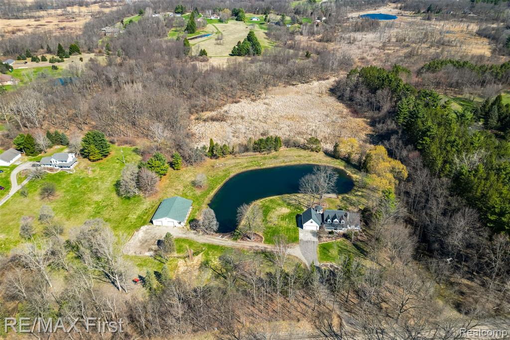 All you need on 15 ACRES or within 15 minutes!  Half acre OMG POND ... the VIEWS (2 newer aerators/waterfall/big fish/bridge), 2200 SF (55'x40' commercial grade metal BARN/building (massive w/cement/office-workshop/2-8' doors/heated/insulated/serious electric w/multiple 220v outlets & dedicated meter/attic storage/covered side 55'x11' porch/patio/neg. shelving/diesel/fuel-tank/graded gravel driveways). HOUSE & WALKOUT SANCTUARY: fully loaded...high quality maple/cherry kitchen cabinetry w/pull-outs/spice rack/trash drawer/island/4 display cabinets/granite/travertine/Bosch dishwasher/built-in appliances/hardwood flooring/recessed lighting everywhere/Andersen doorwall. SCENIC SIX window/3 SKYLIGHTS sitting/family room, PRIMARY ENSUITE w/vaulted ceiling/custom blinds everywhere/walk-in closet/large mediterranean styled tiled primary bath (Jacuzzi/dual sinks/shower/granite).  Upper bedrooms boast JACK & JILL baths & massive bonus bedroom/playroom.  BASEMENT: Walkout or walkup to private garage access/entry... pretty much another house: kitchenette/bar/stove/massive stone hearth/ceramic flooring/multiple rooms/full bathroom/windows/doorwall to massive paver walkway/supersized paver patio/enclosed/screen-enclosed gazebo/screen-enclosed hot-tub house (no hot tub/floored)/maintfree & wood deck/updated high eff furnace & 2021 A/C/4 year old ultimate roofing system/tankless water heater/propane on service plan & half full)/water filtration/updated well/dual tank septic/220V & generator interface/oversized garage (car charger?)/water softener (owned)/insulated garage door/sealed sump pump/brick parking pads/basement garage access).  ONCE IN A LIFETIME ... live/work/play.  Elba Twp. low, low taxes and all sports Nepessing Lake/parks minutes to Metamora/Davison/Lapeer.  Current owner is tax exempt. 2025 Homestead tax 22.259 mills.  Expect high traffic/demand.  ATTENTION AGENTS:  Read MLS Agent Remarks for offer submission & more details.  DO NOT TRESPASS! MAKE APPOINTMENT