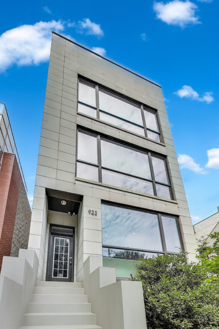 2600 Sq Ft East Village/Wicker Park duplex with stunning upgrades-lives like a SINGLE-FAMILY home! Bright and sunny 3-bedroom, 2.5-bath home offers the perfect blend of thoughtful design, luxurious updates, and functional space. The main level features warm birch hardwood floors, two bedrooms, and an open kitchen area outfitted with an oven plus warming drawer. The upper living room boasts new fireplace surround tile and flows beautifully into a generous dining area. Two generous bedrooms + a glorious half-bath and an en-suite primary with a tub/shower proper wet room complete with STEAM! Downstairs, you'll find an expansive SECOND LIVING SPACE with a full wet bar and room for gym equipment, plus a spacious third bedroom and a full bathroom. Oversized two-story windows flood the home with natural light all day. Private covered garage rooftop with pergola and built-in flower boxes. A full laundry room (not a closet), tons of extra storage throughout, and a separate storage room. New high-efficiency HVAC, new stove and dishwasher. EV charger in garage!