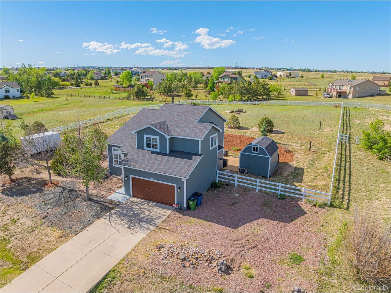 Custom finishes, over an acre of land, RV parking, and no HOA-this home offers the space and flexibility that's becoming increasingly hard to find in Peyton. Situated on 1.05 acres in the desirable Woodmen Hills community, this beautifully updated 5-bedroom, 3.5-bathroom home combines modern updates with room to live, work, and play. Step inside to soaring vaulted ceilings, hardwood floors, and a spacious open layout designed for everyday living and entertaining. The heart of the home is a custom chef's kitchen featuring quartz countertops, custom cabinetry, premium Cafe smart appliances, an Advantium microwave/convection oven, and a 36-inch Z-Line gas range. The adjoining dining and living areas create a seamless flow, anchored by a cozy gas fireplace. Upstairs, the spacious primary suite serves as a private retreat with a sitting area, dual closets, and a luxurious 5-piece bathroom. The fully finished basement expands your living space with two additional bedrooms, a full bathroom, and a large family room perfect for guests, hobbies, a home gym, or multi-generational living. Recent improvements include fresh interior and exterior paint, new carpet, updated bathrooms, updated lighting, new smoke and carbon monoxide detectors, new outlets and switches throughout, refreshed landscaping, and more. Outside, enjoy Colorado sunsets from the stamped concrete patio, work on projects in the workshop shed, or take advantage of gated RV, trailer, and boat parking. As part of the Woodmen Hills Metro District, residents enjoy access to recreation centers, fitness facilities, pools, parks, and trails while still enjoying the freedom of a property without HOA restrictions. This is the rare combination of acreage, updates, amenities, and flexibility that today's buyers are searching for.