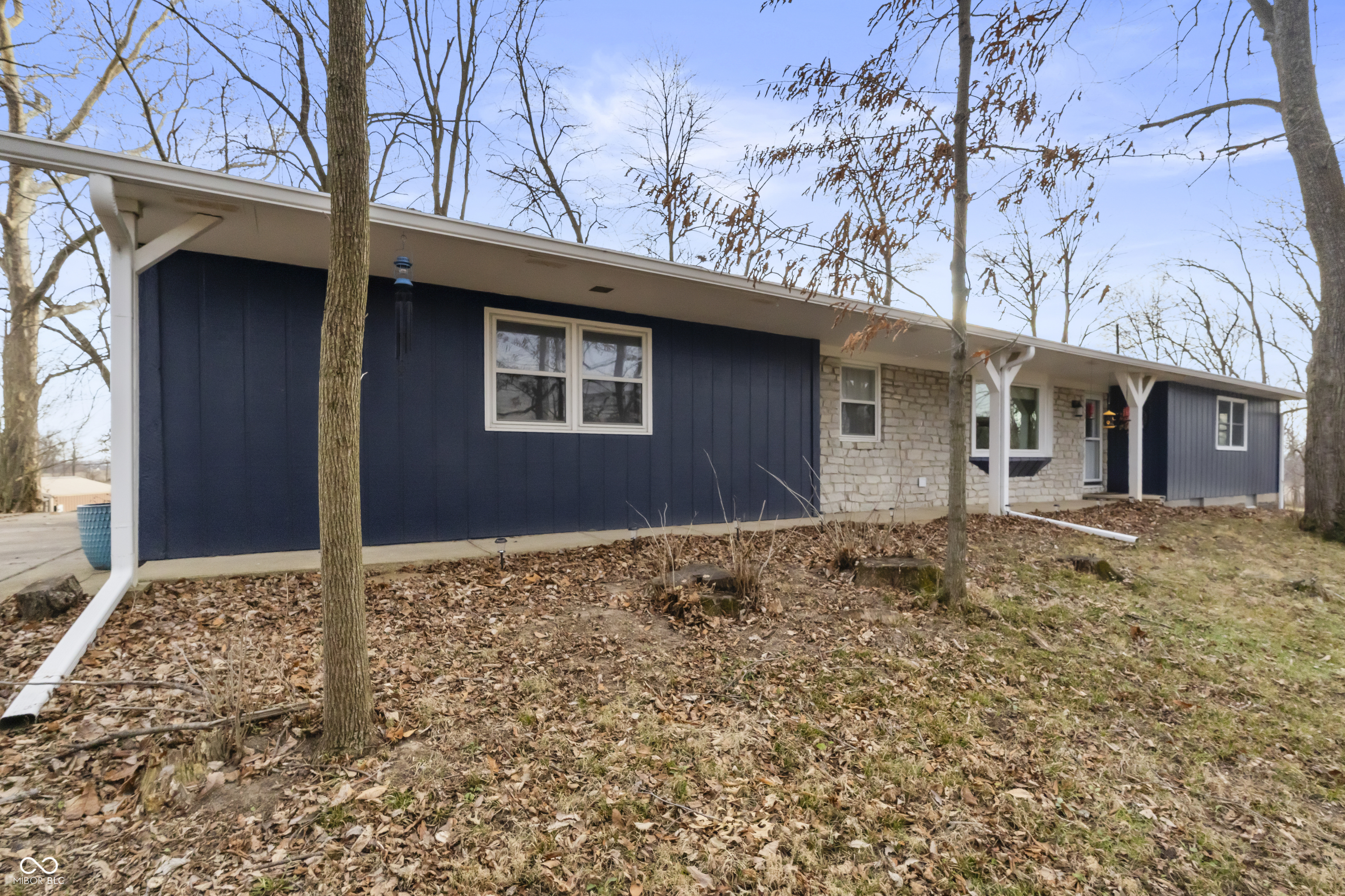 Set on a beautiful 3 acre parcel this thoughtfully updated ranch offers a rare blend of privacy, space & everyday convenience, all just 2 minutes from shopping, dining & easy highway access. Properties with this amount of land so close to town are increasingly hard to find. The main level features hardwood floors, a bright & welcoming layout with abundant natural light. A spacious sunroom overlooks the serene setting & provides a seamless connection between indoor living & the surrounding landscape. The kitchen is both functional & refined featuring custom cabinetry & granite countertops, designed for comfortable daily living & entertaining. The finished basement expands the home's versatility with a home theater area, wet bar, large private office & half bath, ideal for remote work, hobbies, or hosting guests. With 3 bedrooms & 2 full plus 2 half bathrooms, the layout offers flexibility & comfort throughout. There have been many recent exterior improvements over the last 4 years. Including a roof, seamless gutters with leaf guards, most of the windows have been replaced. Major mechanical updates such as a newer HVAC system, water heater, water softener & updated electrical components provide peace of mind. Outside, the land truly sets this property apart with mature trees, newly planted evergreens, fruit trees, garden space & a large fire pit. A barn with 2 large animal stalls, electricity, & lighting, ideal for hobby farming, livestock, or workshop use.  As well as a separate chicken coop, this home offers endless possibilities. This is acreage living without the tradeoffs of a remote location. Extensive improvements inside & out make this a rare opportunity to enjoy acreage living without sacrificing convenience. **CR 400 N is also called Paul Hand Blvd, this is better using maps apps.