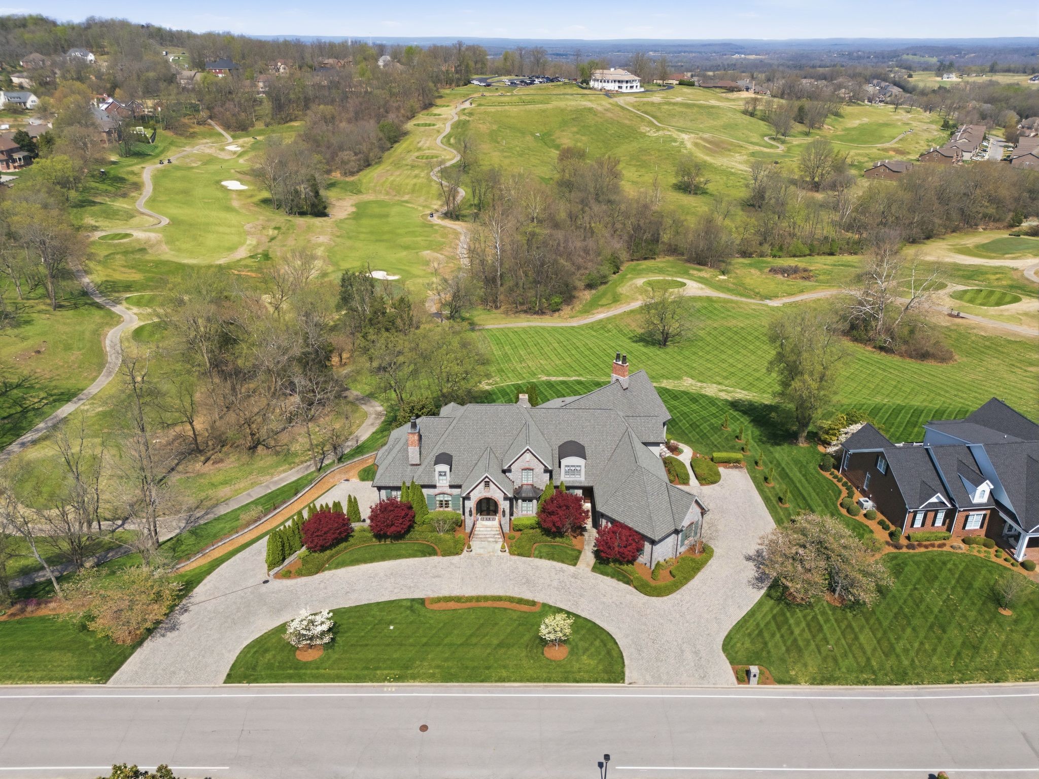 Collector-Car Dream on the Golf Course — Basement Garage Holds 8–10 Cars!  Experience unrivaled luxury and car-collector convenience in prestigious Five Oaks. Custom-built by a respected local builder, this executive estate sits on 2.3 private acres overlooking the golf course and offers ~12,517 sq ft of impeccably finished living space. The temperature-controlled, fully finished basement garage is a standout — engineered to house 8–10 vehicles with room for a workshop, display lighting, and secure storage, plus a built-in safe room for added peace of mind. 2 elegant primary suites (one main level, one upstairs) and 3 additional bedrooms, 4 full baths, 3 ½ baths provide flexible living. The main-level primary suite offers a spa-like retreat with a steam tile shower, soaking tub, double vanities, a separate makeup vanity, and expansive His & Her walk-in closets with built-in cabinetry. The gourmet kitchen is a true showpiece with glazed cabinetry, exquisite calcutta marble countertops, a gas cooktop with pot filler, double ovens, two built-in Sub-Zero refrigerators, 2 dishwashers, a large pantry, and a wood-topped island. Entertain effortlessly with formal dining, complemented by a well-appointed butler’s pantry with granite and an ice maker; Outdoor living is unmatched with screened porch, a covered back porch with beadboard ceiling, and a pergola with golf-course views perfect for relaxing or entertaining.  Exceptional finishes include crown molding, coffered wood-beam ceilings in the office, whole-home audio (outdoors included), two gas-log fireplaces, a wood-burning fireplace with a gas starter, a central vacuum, a hobby room, and a large laundry room with a convenient laundry shute.  Built for longevity and efficiency with a 50-year roof, copper gutters, and four HVAC units. Convenient to I-40, I-840, Hwy 109, and just 20 minutes to Nashville International Airport. Ideal for discerning buyers seeking luxury living and a professional-grade car collection home.