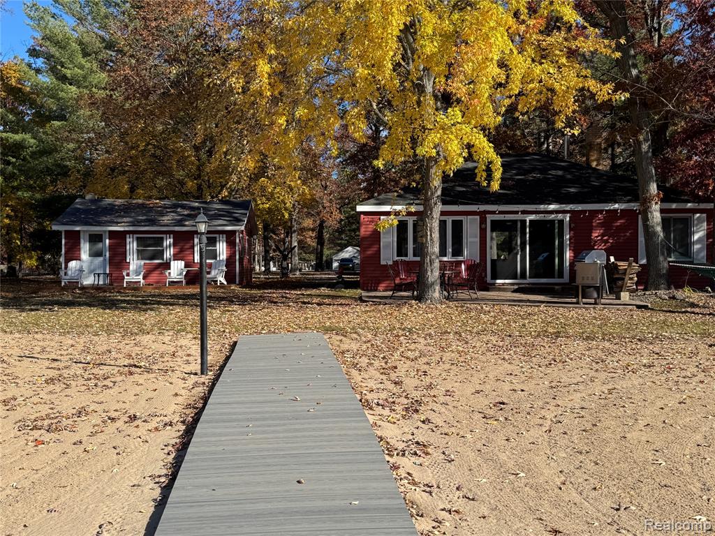 Unique Opportunity! Beautiful 100 Ft lakefront compound on Jose Lake—an all-sports lake offering stunning views and a sandy beach frontage. The main cabin features just over 1,000 sq. ft. with 2 bedrooms, 1 full bath, and an open floor plan designed for comfort and entertaining. Includes all stainless-steel appliances and a cozy wood-burning stove for those chilly evenings. Step through the 8-ft. sliding door to a spacious stamped concrete patio, perfect for barbecuing, relaxing, and enjoying the breathtaking sunsets. Property sits on approximately 3/4 of an acre with sandy beach frontage across the entire waterfront. New Septic 2022. In addition to the main home, there are three additional mini-cabins on the property—two of which are newer construction providing a total of five bedrooms and two full baths across the property. Ideal for a large family compound, multi-family use, or guests seeking privacy. Cabin 1: Approx. 19' x 15' with a sitting area, lots of natural light, and direct lake views. Updated in 2018, propane heat, engineered wood flooring, cathedral ceilings with decorative beams and metal accents, charming front porch. This cabin includes washer and dryer for added convenience. Cabin 2: Approx. 15' x 10' with vinyl flooring, cathedral ceiling, and propane heat with thermostat control. Cabin 3: Approx. 15' x 20' with vinyl flooring, cathedral ceiling, electric heat, cozy sitting area, and small front porch. The property includes a 40' x 25' pole barn with a gravel floor ample space for all your lake toys, vehicles, and lawn equipment. The second full bathroom is located here, extremely functional for gatherings or summer use. Easily fits four vehicles inside. There’s also an additional 25' x 16' garage complete with a pool table (included), workbench, storage area, and two overhead garage doors plus one large sliding door. Panoramic lake views that will take your breath away. The setting is perfect—quiet, scenic, and positioned beautifully on the lake.