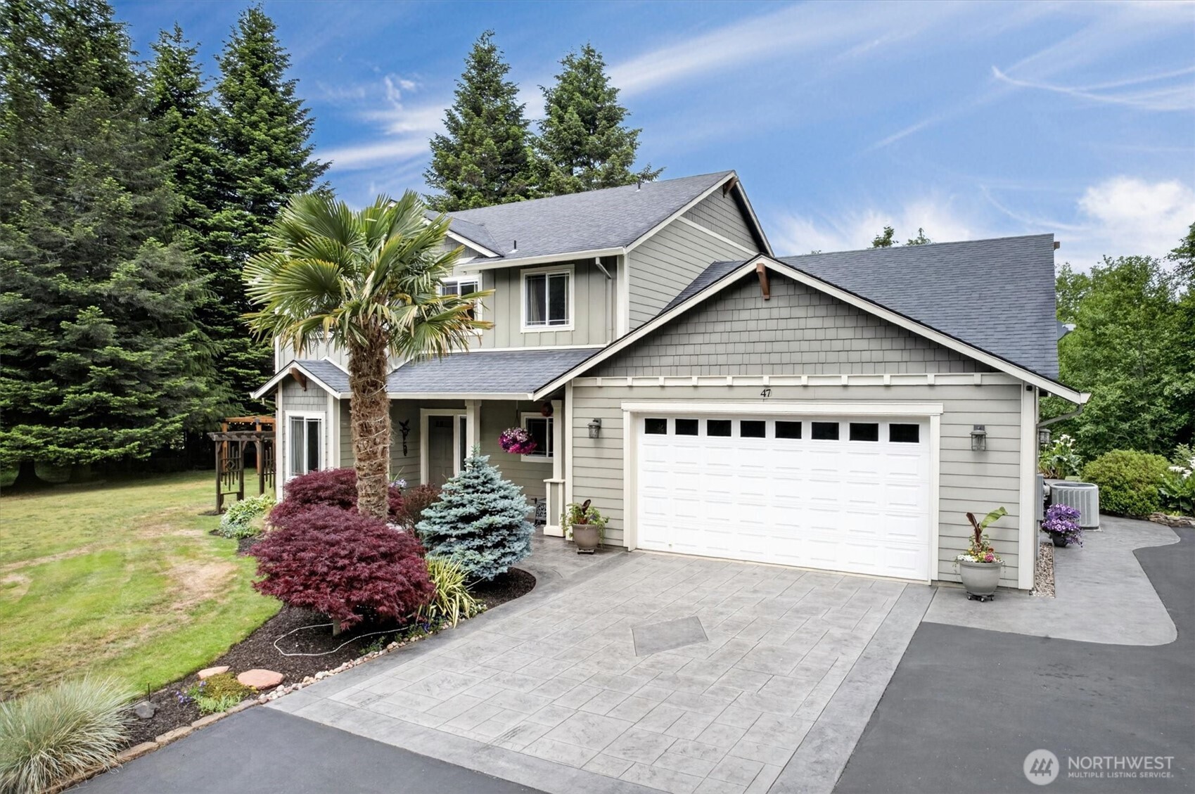 Welcome home! Tucked away on 4.5 beautiful acres at the end of a quiet dead-end road, this thoughtfully designed 4-bedroom, 2.5-bath home offers the perfect blend of comfort, privacy, and easy living. Built in 2011, the spacious floor plan features an open-concept kitchen with granite countertops, stainless steel appliances, soft-close cabinetry, and a layout that flows seamlessly into the main living area—perfect for gathering with friends. The main-floor primary suite is a relaxing retreat with vaulted ceilings, a walk-in closet, heated bathroom floors, a soaking tub, and a separate shower. An office and laundry room on the main level make everyday living convenient, with no need to head upstairs unless you want to. Upstairs you'll find three additional bedrooms, a second living area, and a full bath with heated floors.Step outside and enjoy everything this property has to offer. A stunning stamped concrete patio wraps around much of the home, leading to a covered entertaining space and cozy fire pit. Mature landscaping reflects years of pride in ownership, while the wooded back acreage slopes gently to a peaceful creek. Located just over an hour from Portland and the Oregon/Washington Coast, Cathlamet offers small-town charm with easy access to everywhere you want to be. This is it!
