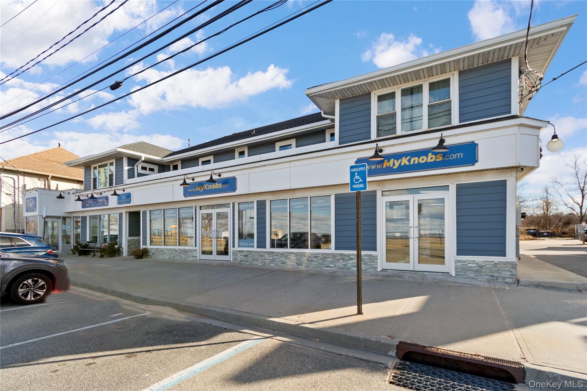 Now available for lease, this premier ground-floor commercial space at 14 Bayville Avenue offers a rare waterfront retail or office opportunity in the heart of Bayville. Completely renovated in 2019, the property features approximately 5,000 square feet of modern, functional space designed to accommodate a wide range of professional or showroom uses. The layout includes a bright showroom area, private back offices, a dedicated call center, and a full kitchenette. The space is fully ADA compliant, boasting two ADA-accessible front entrances, three ADA-compliant restrooms, and a convenient rear entrance/exit. Additional highlights include oversized windows with custom blinds, central HVAC throughout, and 25 on-site parking spaces. Situated in Bayville’s charming waterfront community, the property benefits from close proximity to marinas, beaches, local shops, restaurants, and strong foot traffic. This turnkey space combines visibility, accessibility, and exceptional signage. Space is divisible!